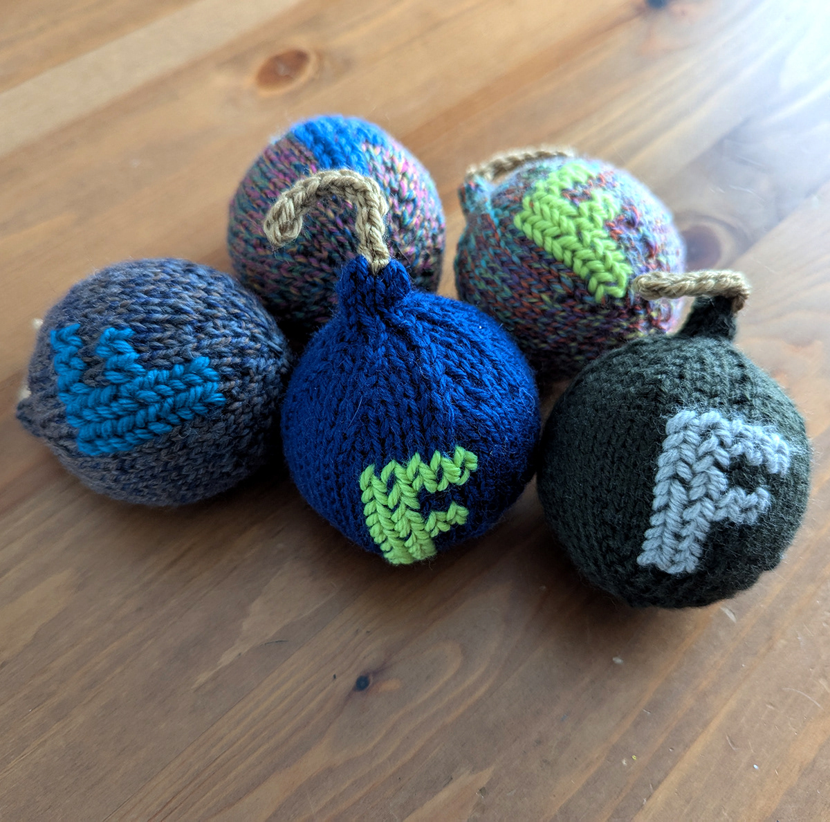 Knitted bombs with the letter F stitched on the front