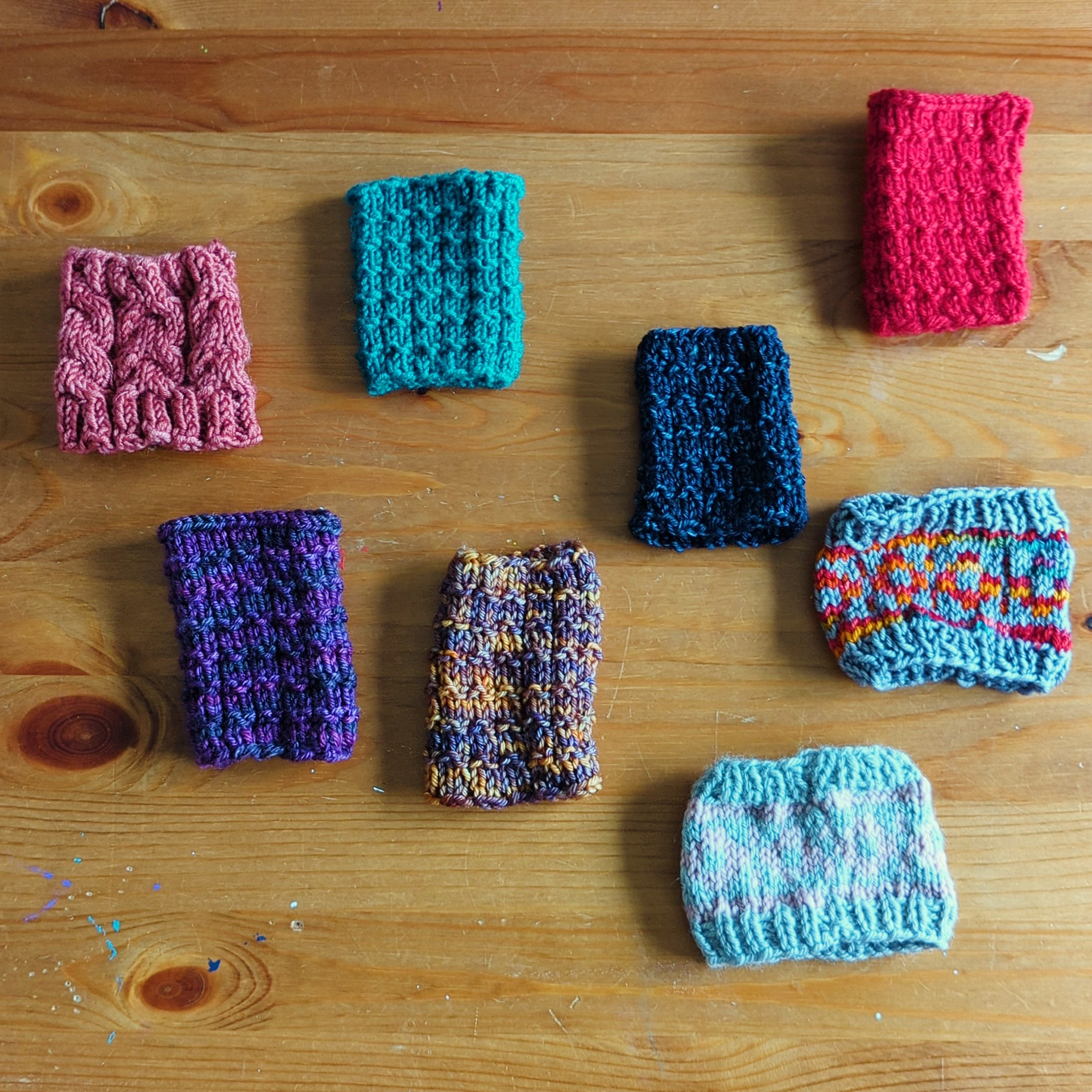 Various knitted coffee sleeves