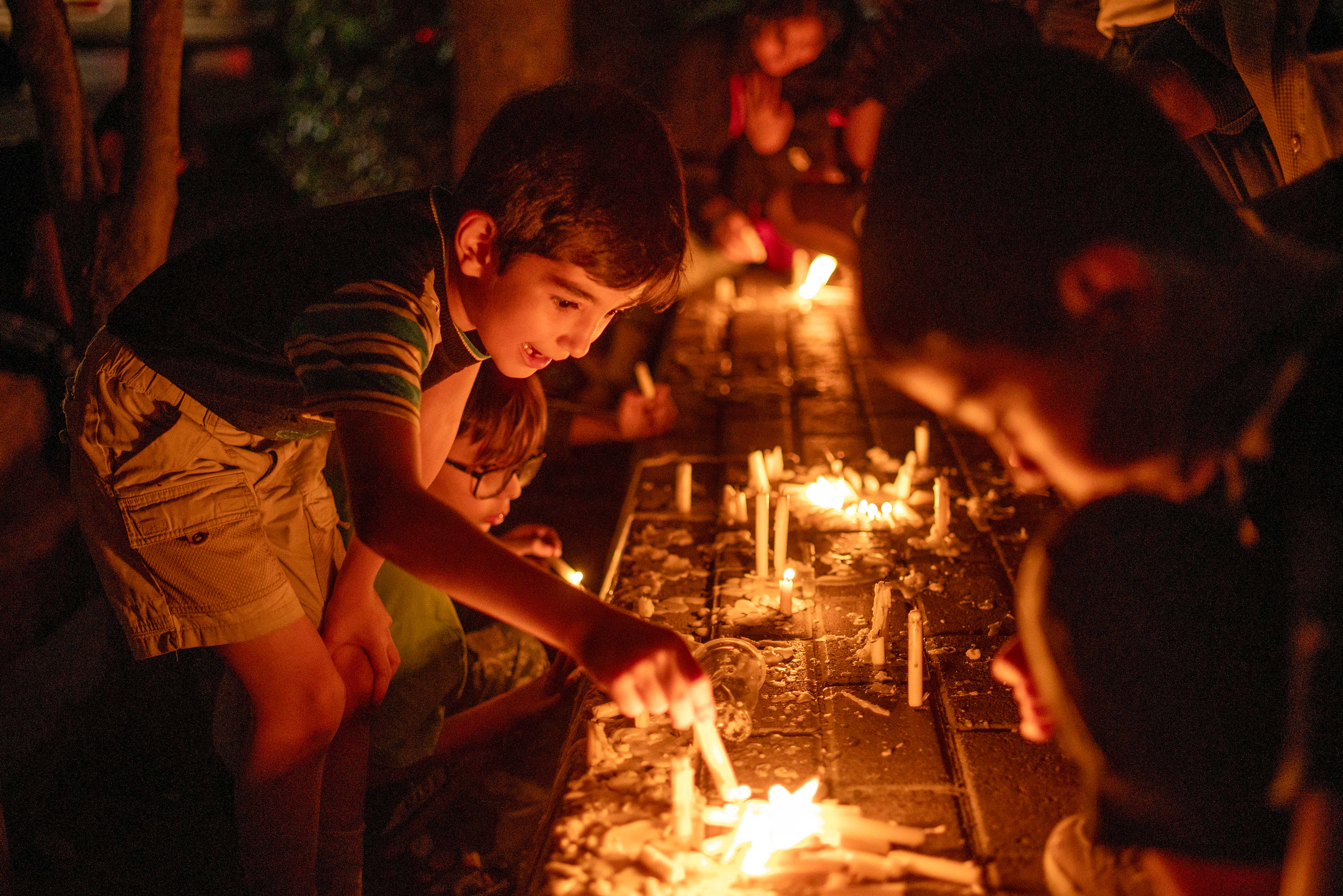 Children light candles, in Tabriz, Iran on July 27, 2023, bringing 'a light for Imam Hussein' on Tasua Day the 1384th anniversary of the martyrdom of Imam Hussein, the grandson of the Islamic Prophet Muhammad, and 72 of his companions in Karbala.