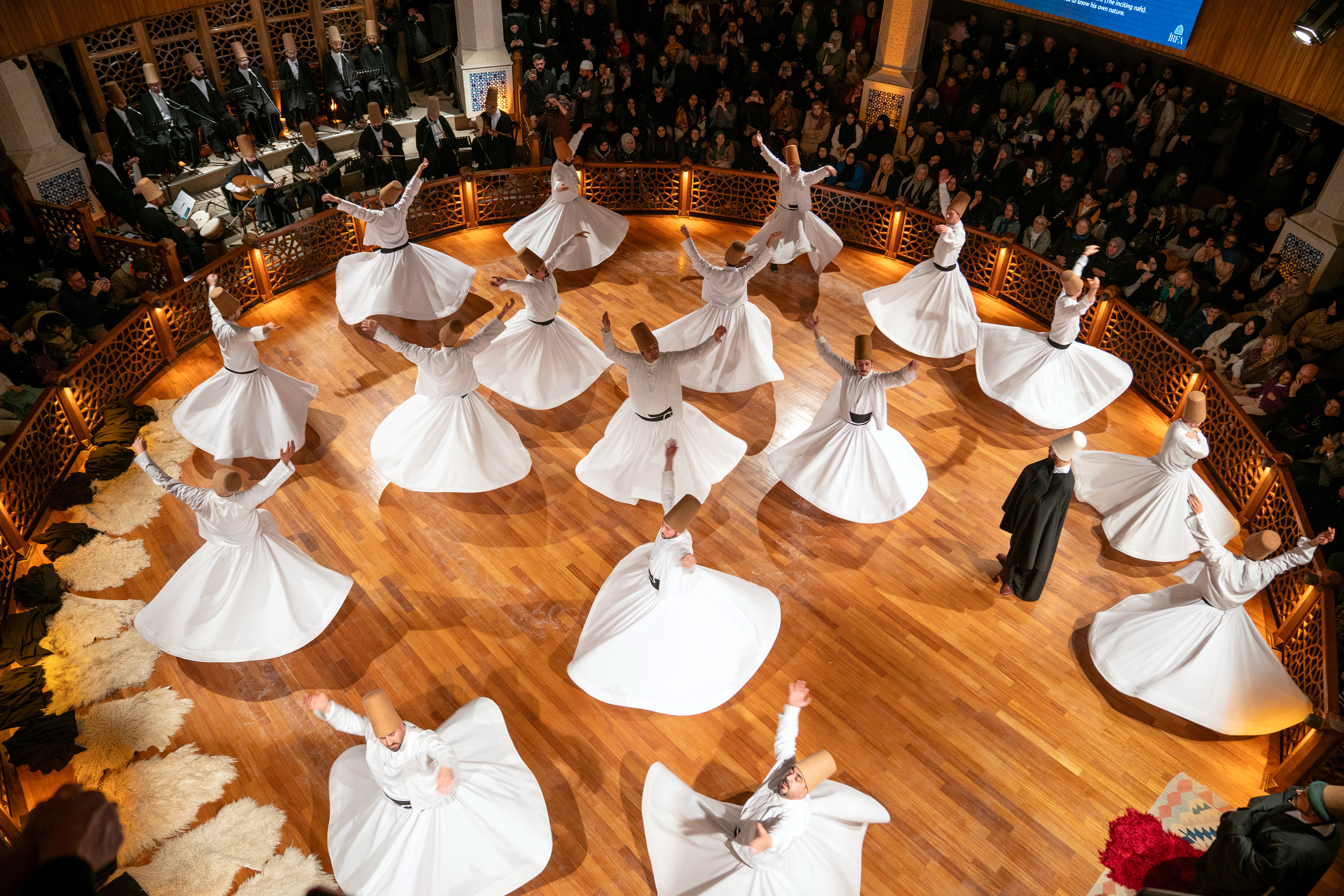 Whirling dervishes perform during at the ''Seb-i Arus'' ceremony on the 750th death anniversary of Mevlana at Konya's Irfan Civilization Research and Culture Center.. Mevlana Celaleddin-i Rumi is a Sufi mystic poet who lived in the 13th century.