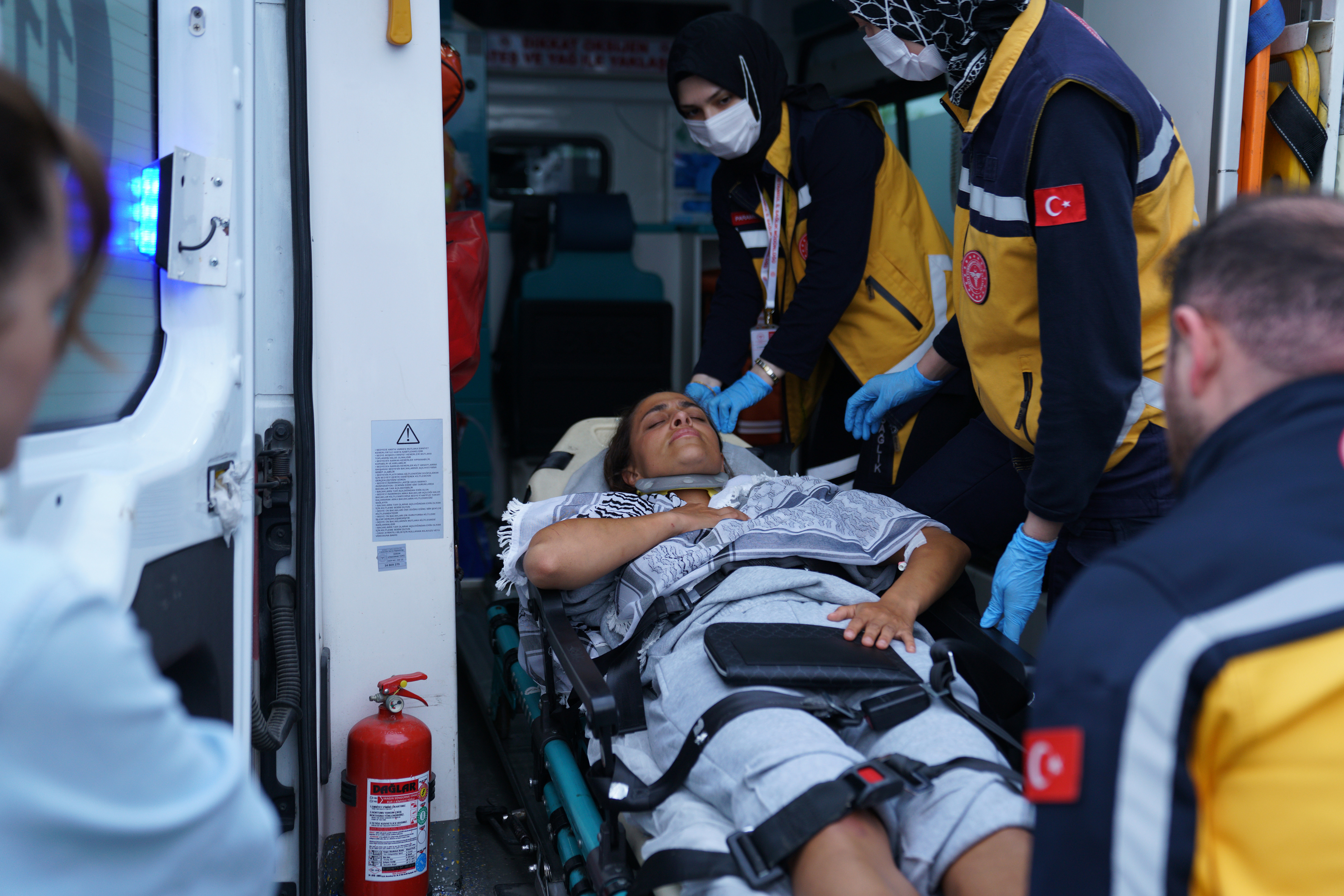 An activist, who was detained aboard the Gaza-bound Global Sumud Flotilla, which was intercepted by Israeli forces, is loaded into an ambulance on a stretcher at Istanbul International Airport after being deported, in Istanbul, Turkey, May 21, 2026.