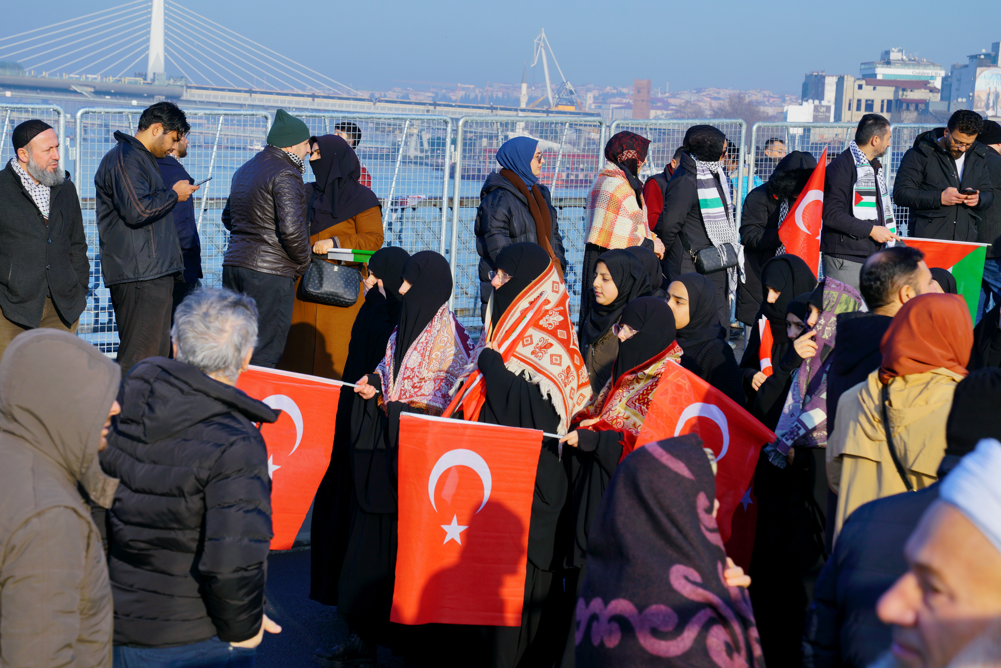 Pro-Palestine people hold Turkish flags during march in solidarity with Palestinians in Gaza over the Galata Bridge in Istanbul on January 1, 2025.