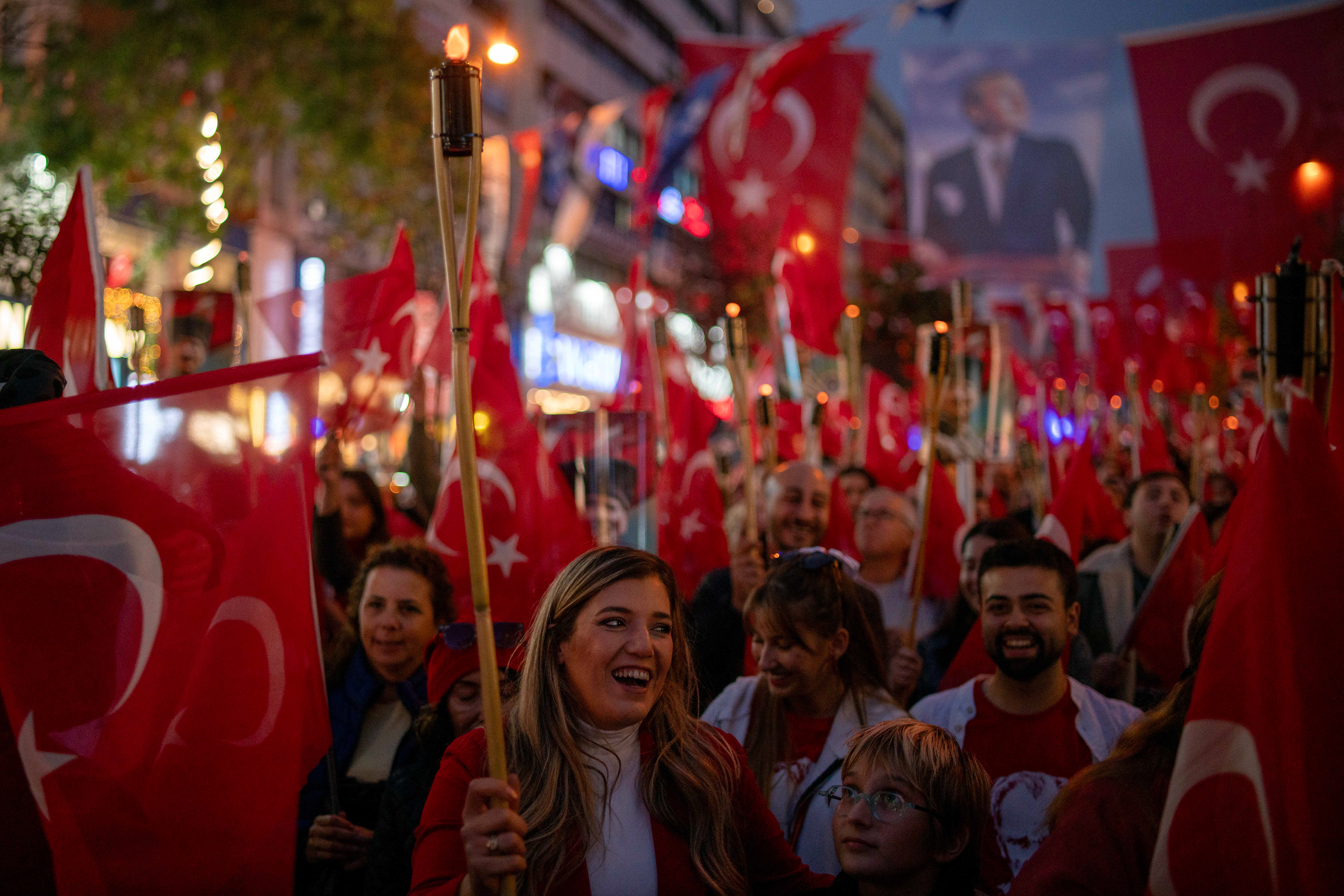 People hold candles and wave the Turkish flag at the Republic March held for the 101st anniversary of the Republic of Turkey in Sisli, Istanbul, on October 29, 2024. Turkey is celebrating the 101st anniversary of the Republic of Turkey founded by Mustafa Kemal Ataturk.