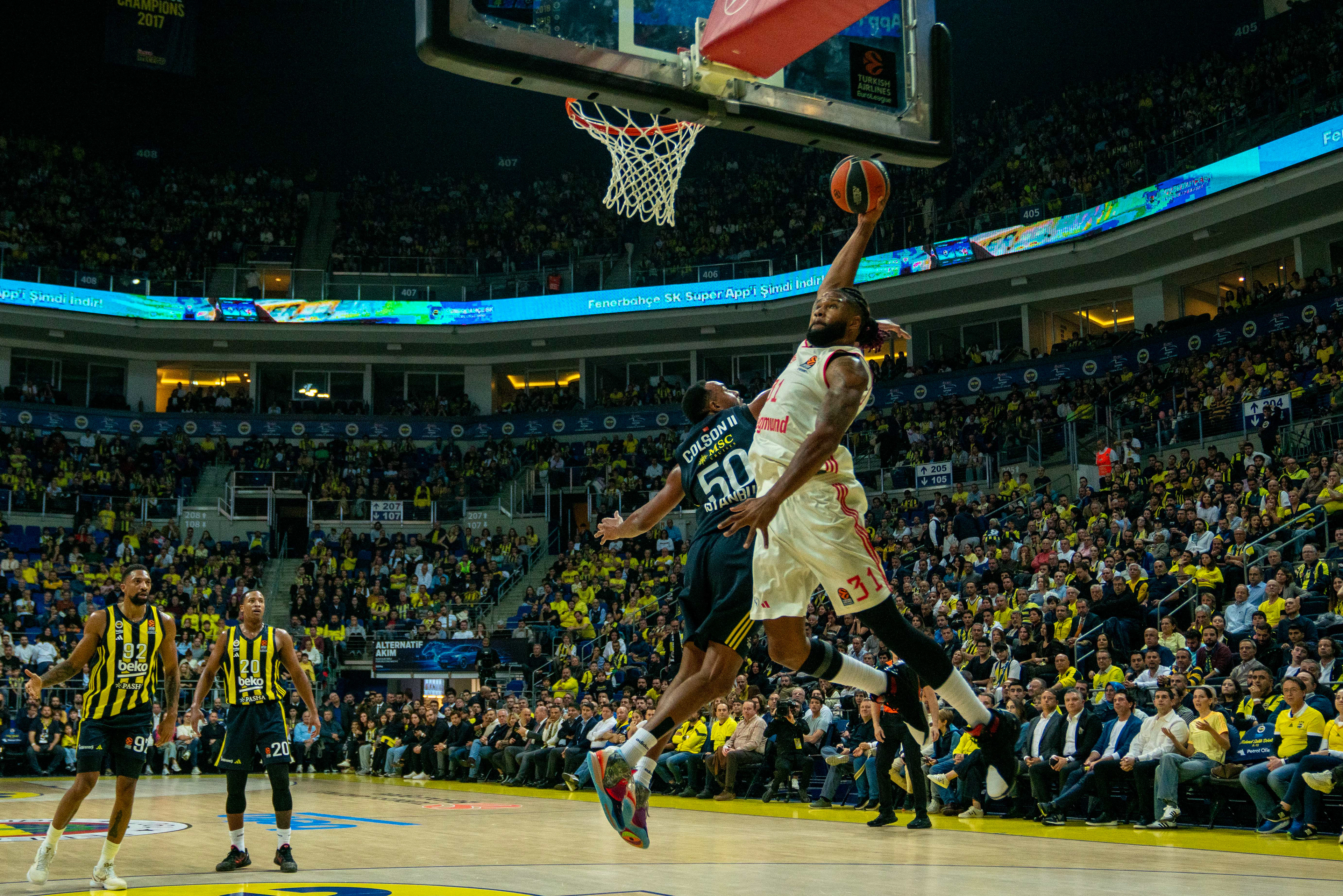 Bonzie Calson (down) of Fenerbahce in action against Devin Booker (up) of Bayern Munich during the EuroLeague during the EuroLeague Basketball match between Fenerbahce vs Bayern Munich in Istanbul, Turkey on November 12, 2024.