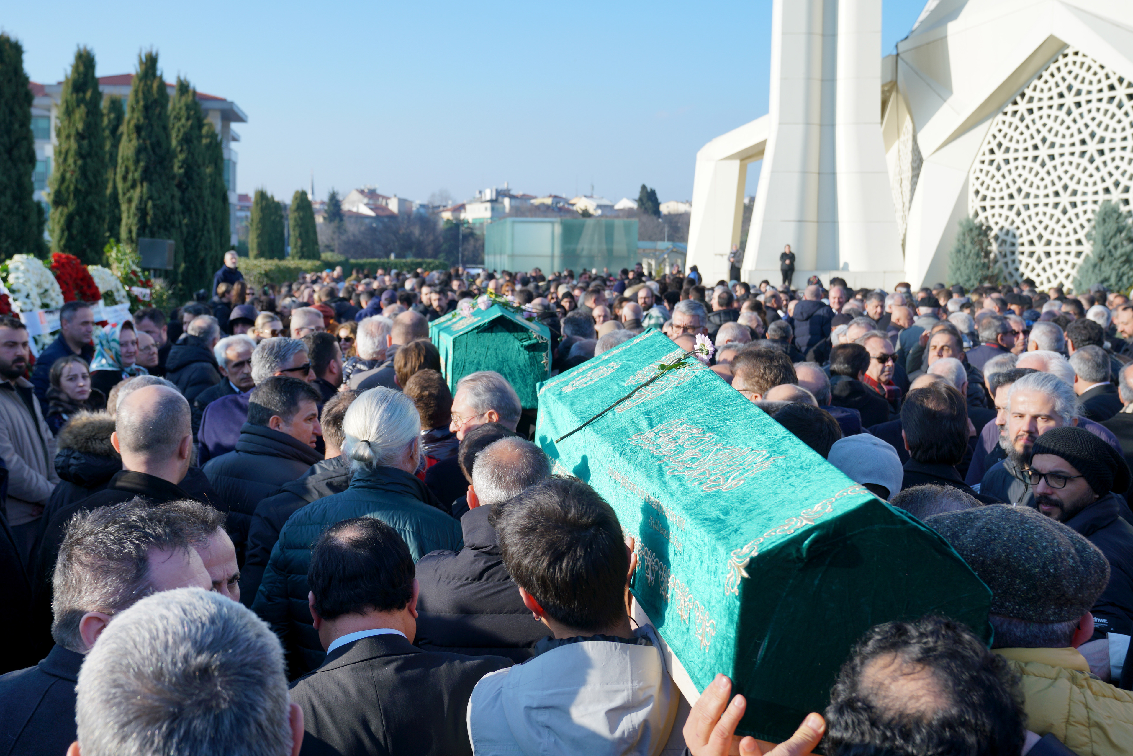 Mourners carry two coffins after the funeral of Turkish journalist Nedim Turkmen and his family in Istanbul, Turkey, 22 January 2025.