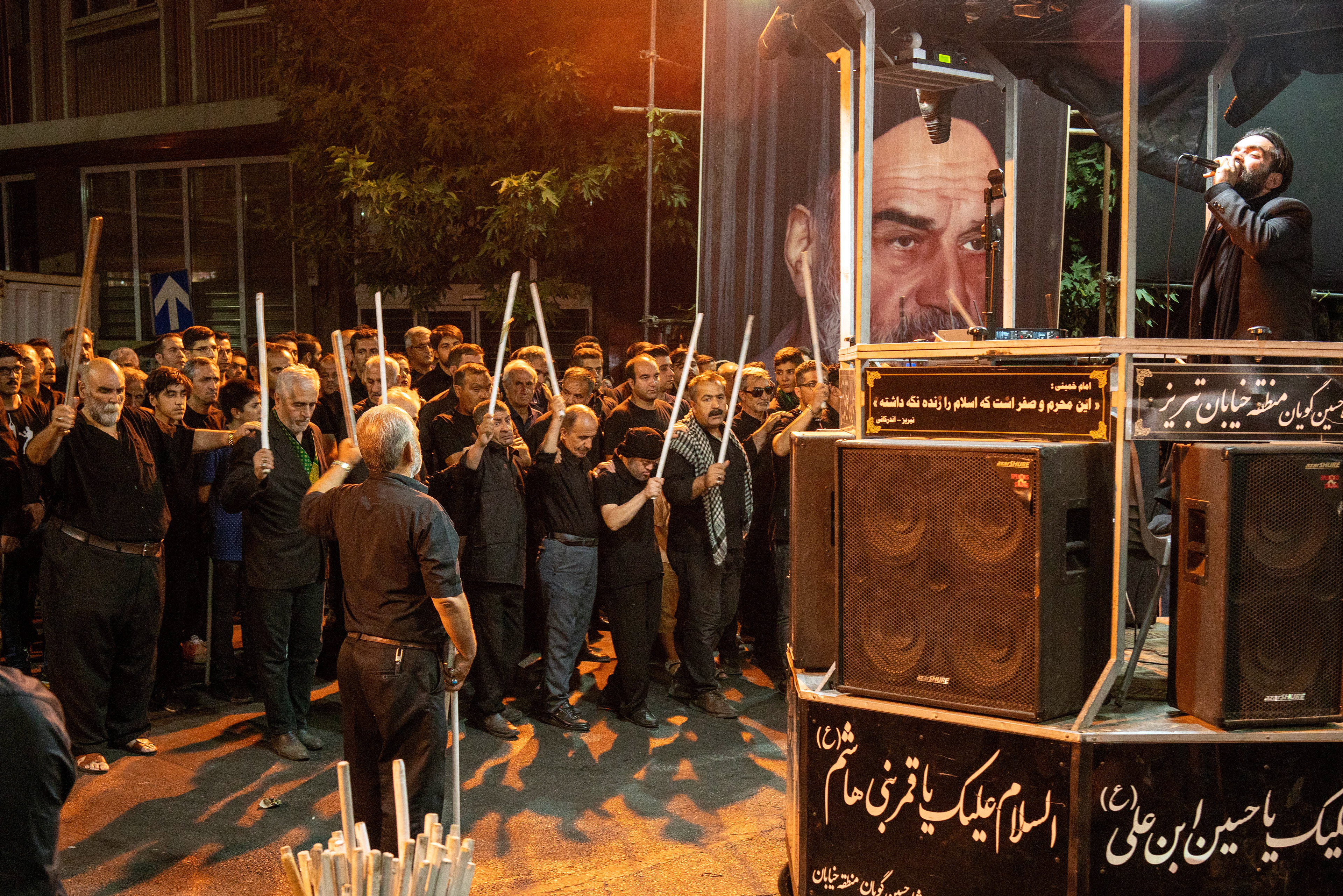 Shiite Muslims in Iran, sing hymns and beat themselves in a certain rhythm with stick called 'sine vurmak' (hit the breast) in small groups called 'deste'. On Tasua, the ninth day of Muharram, Shiite Muslims, dressed in black, mourn in squares and mosques on the 1384th anniversary of the martyrdom of Imam Hussein, the grandson of the Islamic Prophet Muhammad, and his 72 companions in Karbala.