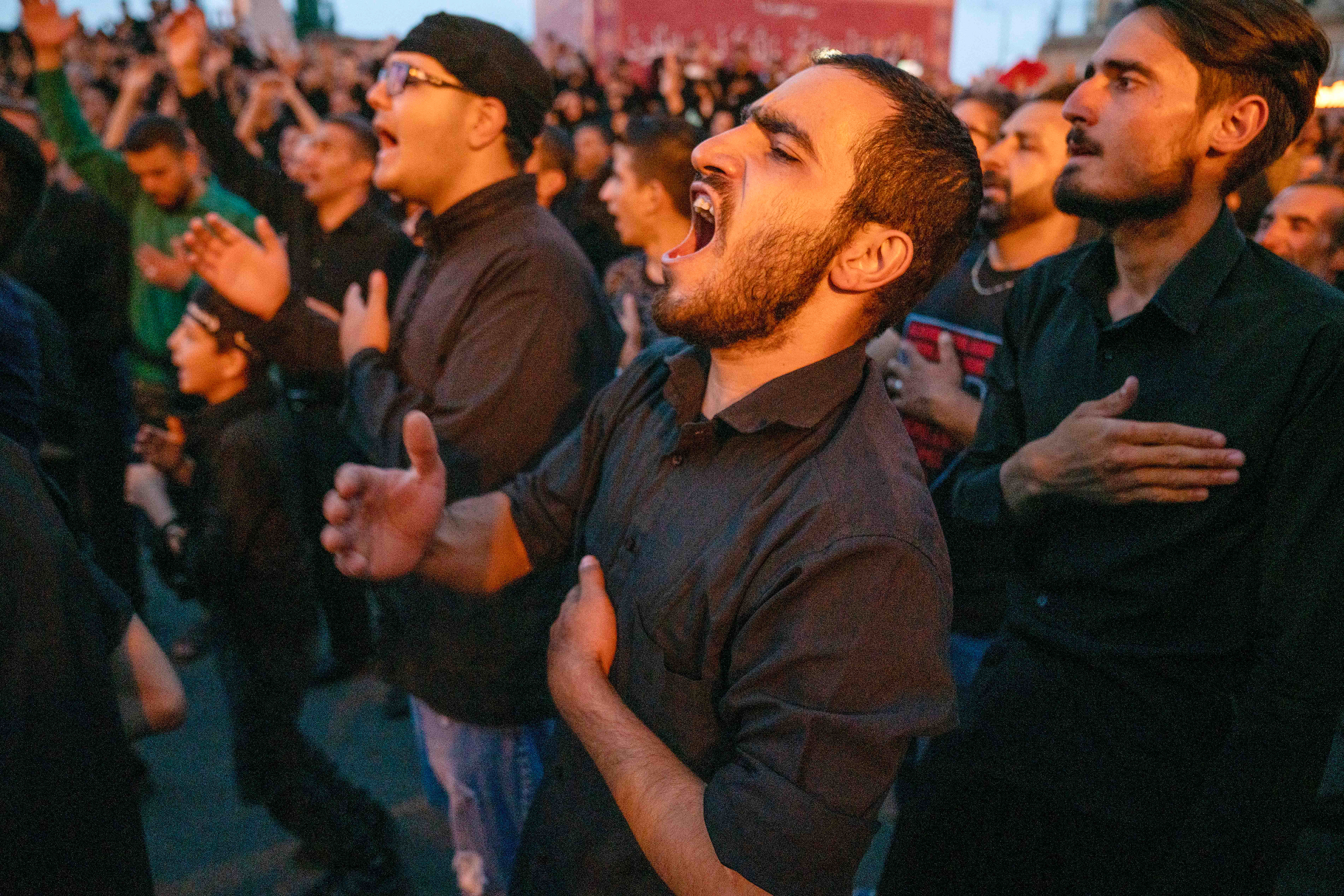 On the day after the Day of Ashura, the 1384th anniversary of Imam Hussein's martyrdom, a man sing hymns in Enghelab Square, Zanjan, Iran, on July 29, 2023, and beating themselves in a certain rhythm called 'sine vurmak.'