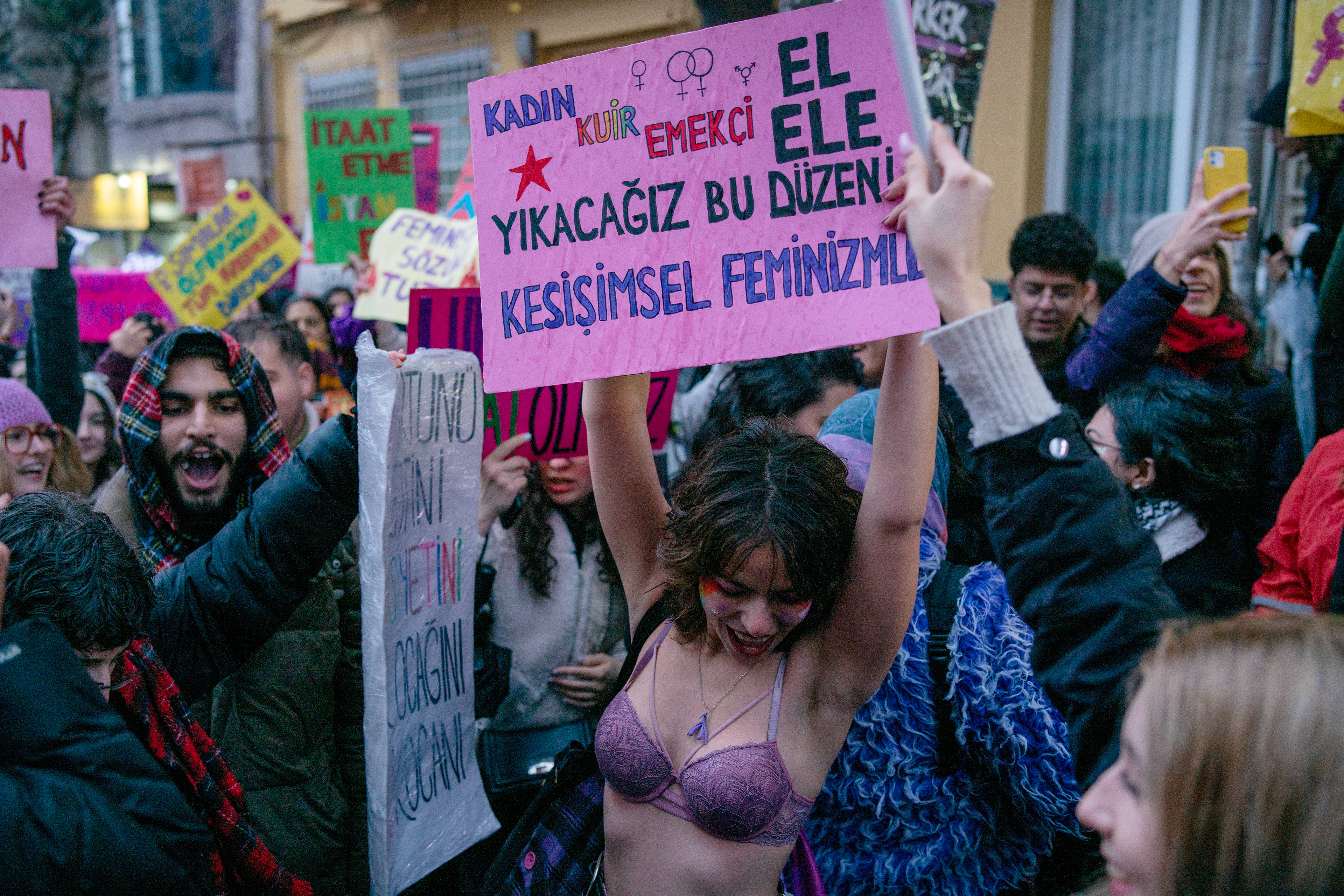 A demonstrators hold banner during a march from the Cihangir in Taksim to Taksim Square, at the Feminist Night March to mark International Women's Day, in Istanbul on March 8, 2024.