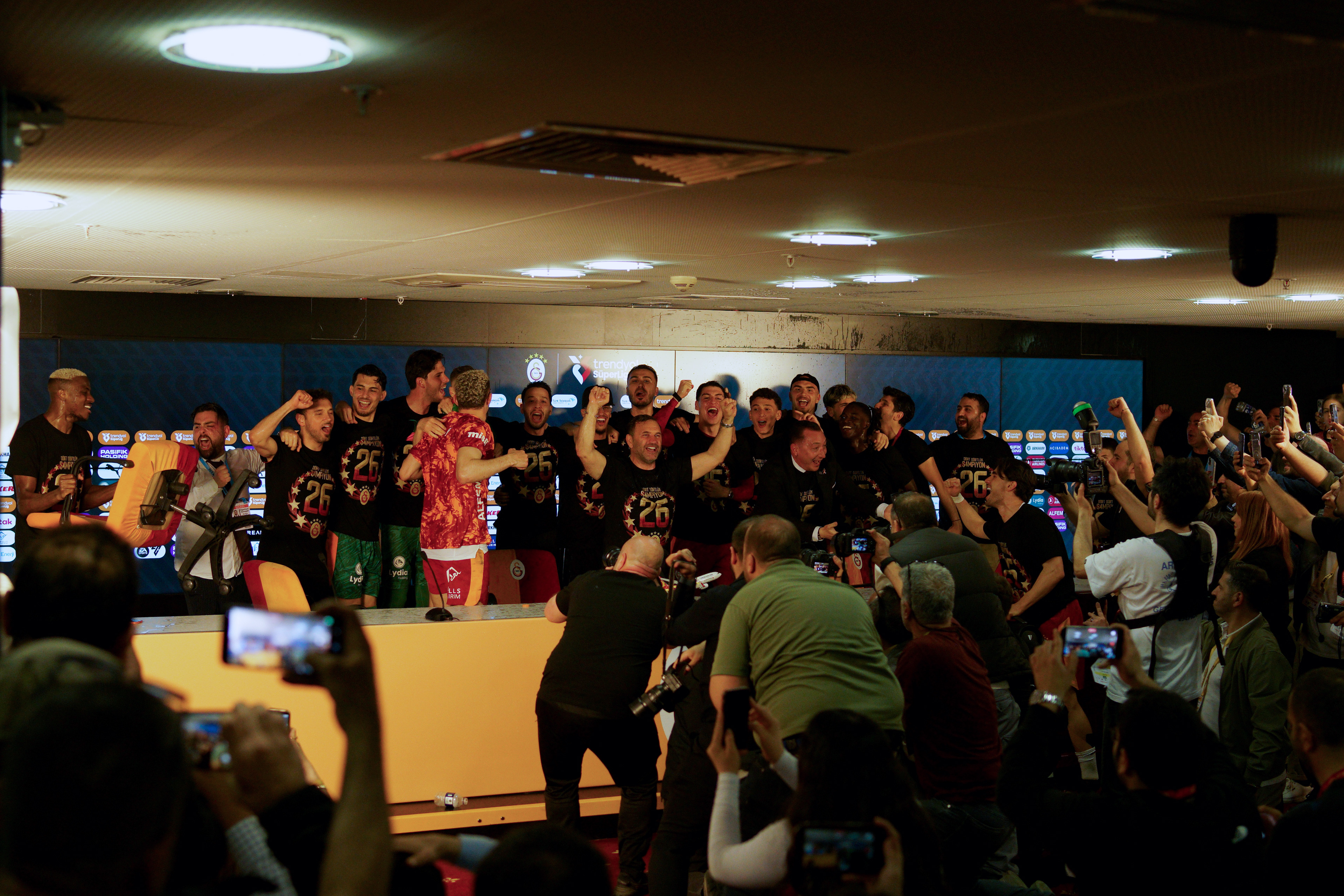 Galatasaray players and coach Okan Buruk celebrating their 2025-2026 Turkish Super League championship in the press room during a match played in Istanbul on May 9, 2026.