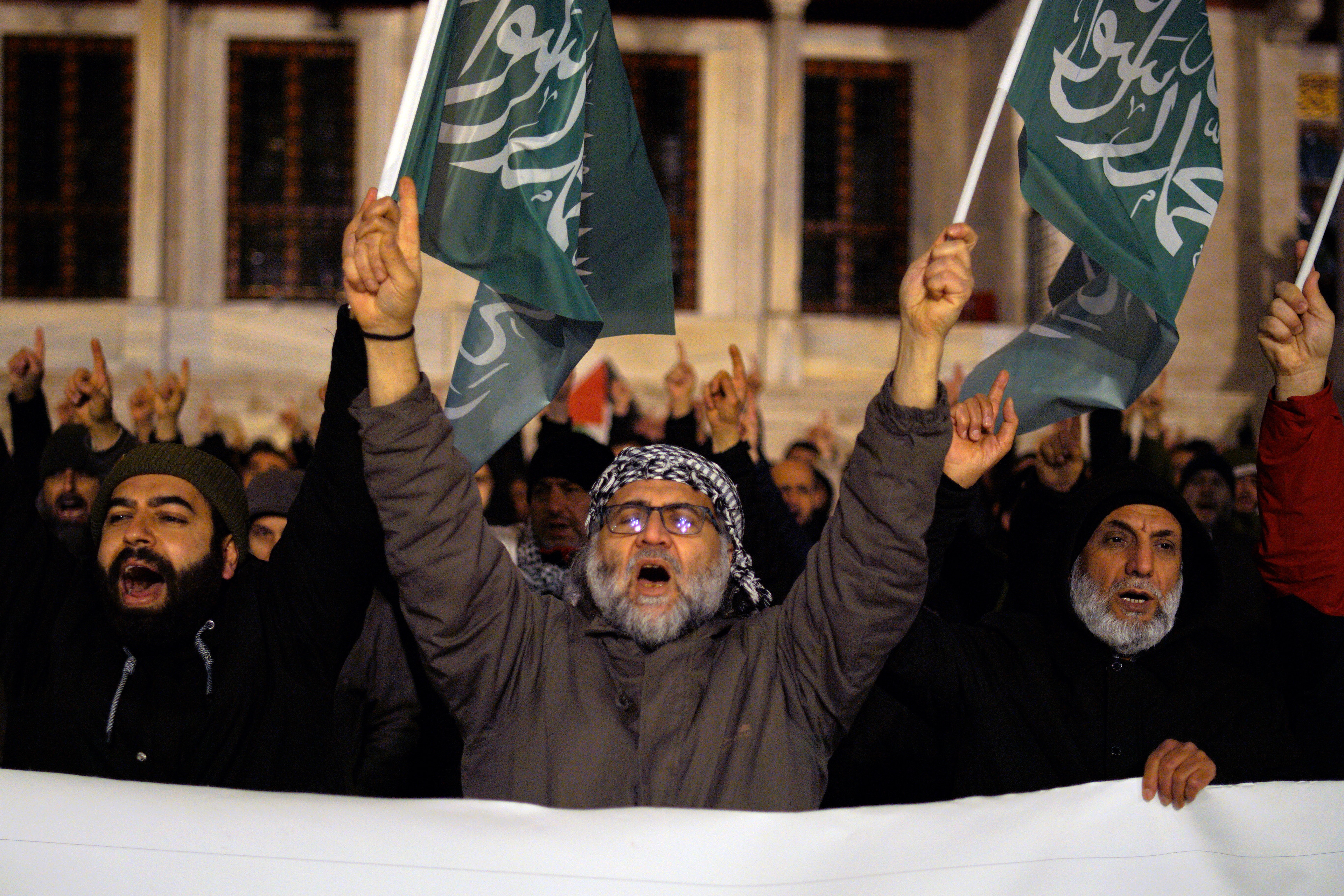 Protesters hold Islamic Tawhid flag as they shout slogans during a pro-Palestinian protest aftermath Israel's violation of the ceasefire and launch of an offensive on the Gaza Strip outside Fatih Mosque in Istanbul on March 18, 2025. The ceasefire between Hamas and Israel went into effect on January 19, 2025.