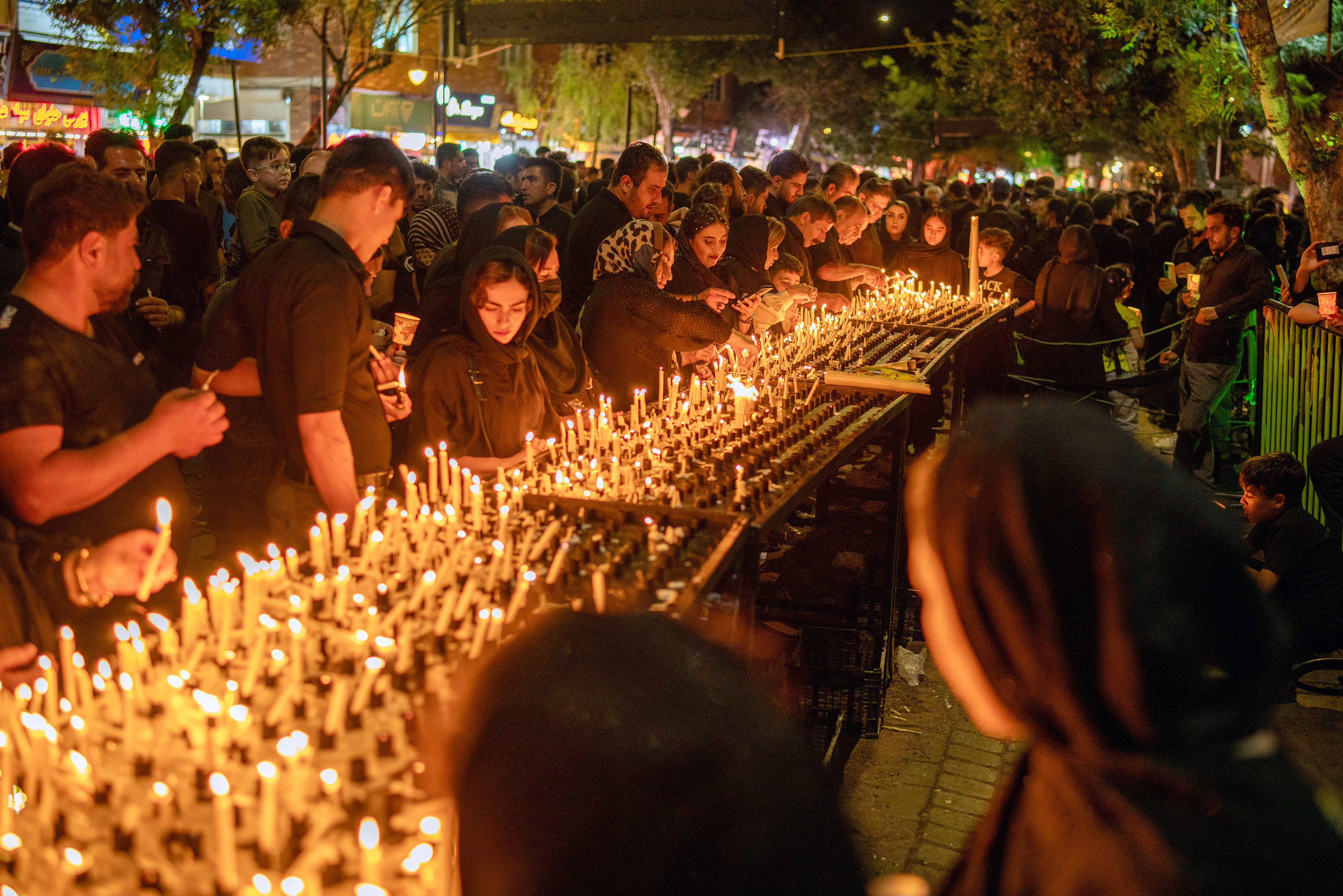 Shiite Muslims in Ardabil lights a candle to being a light for Imam Hussein on Ashura Day the 1384th anniversary of Imam Hussein's martyrdom. Shiite Muslims in black mourn in squares and mosques on Ashura, the teenth day of Muharram.
