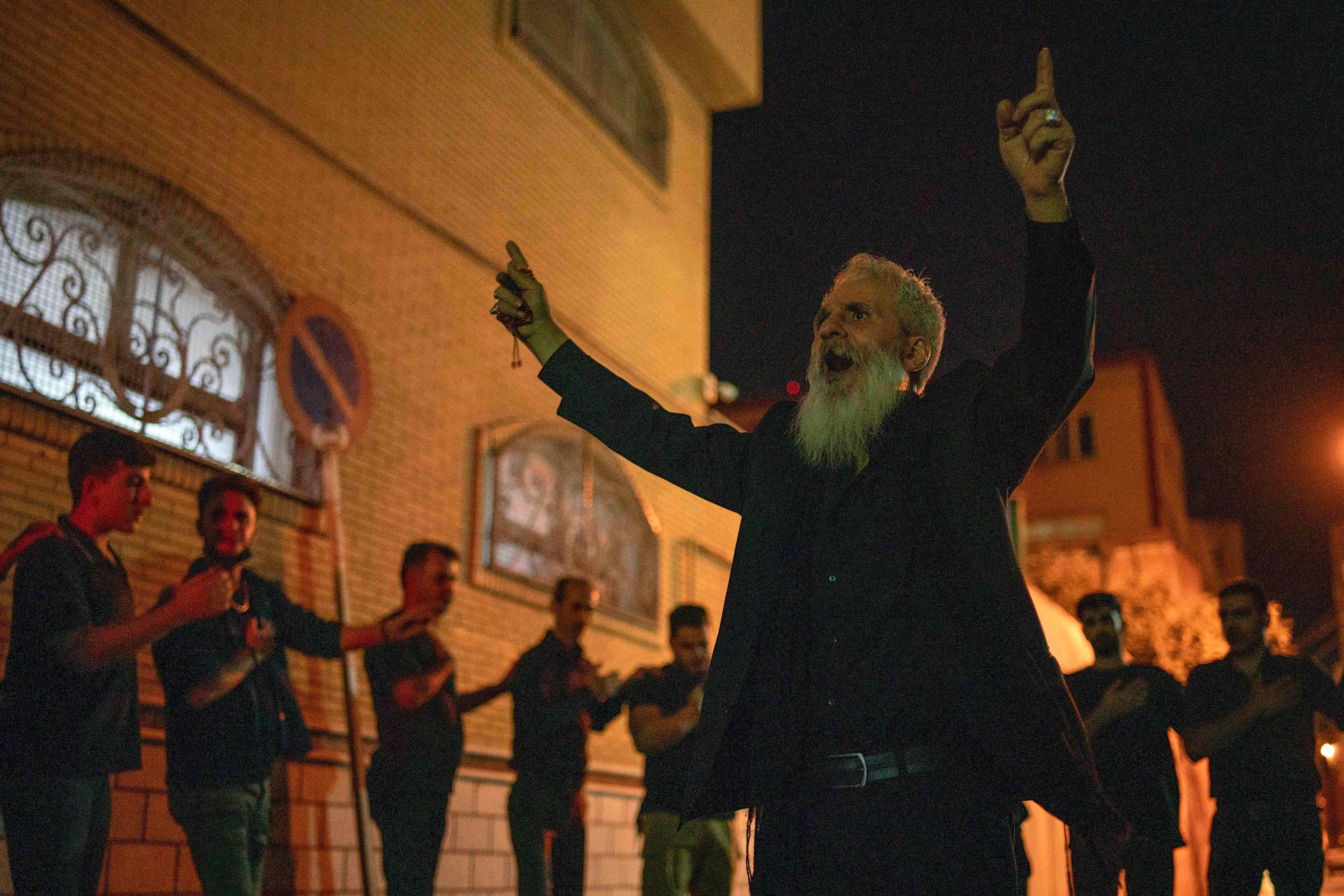 The head of the group gives rhythm to the hymns sung by small groups, called 'deste', in the Tasua commemoration ceremony, one day before the Day of Ashura, 1384th anniversary of Imam Hussein's  martyrdom, in Tabriz, Iran on July 27, 2023.  On Tasua, the ninth day of Muharram, Shiite Muslims in black mourn in squares and mosques. 