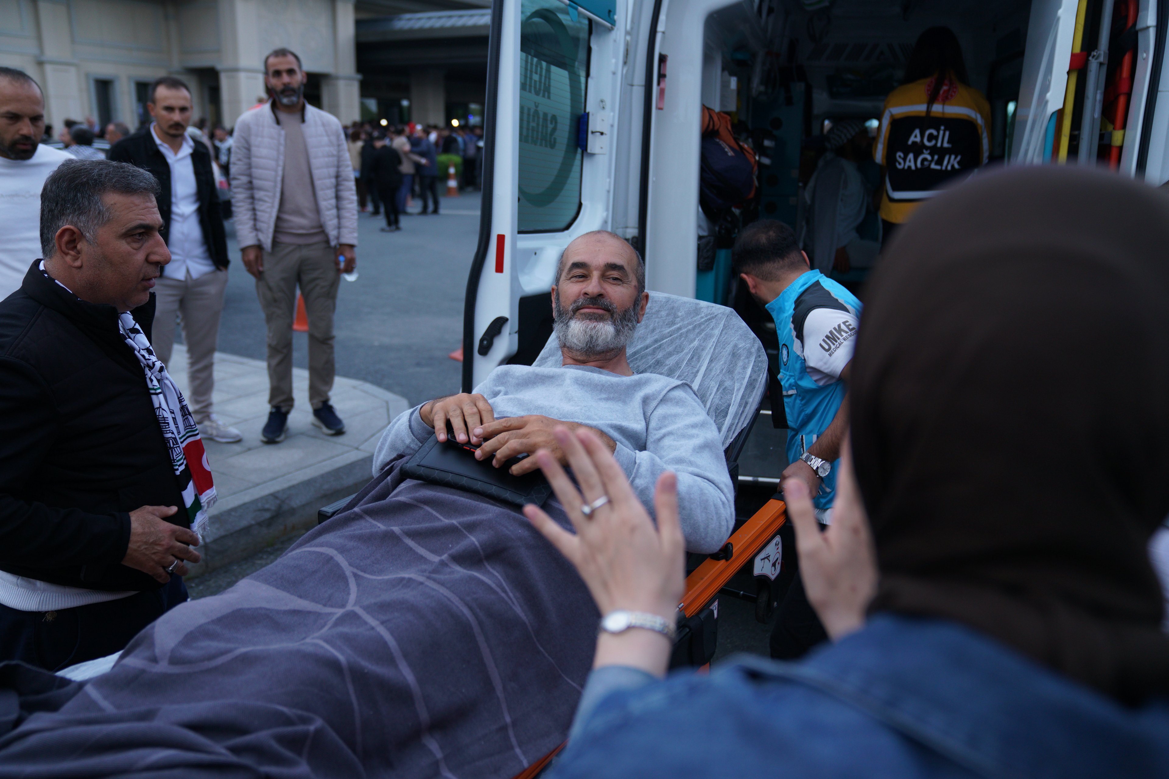 An activist, who was detained aboard the Gaza-bound Global Sumud Flotilla, which was intercepted by Israeli forces, is loaded into an ambulance on a stretcher at Istanbul International Airport after being deported, in Istanbul, Turkey, May 21, 2026.