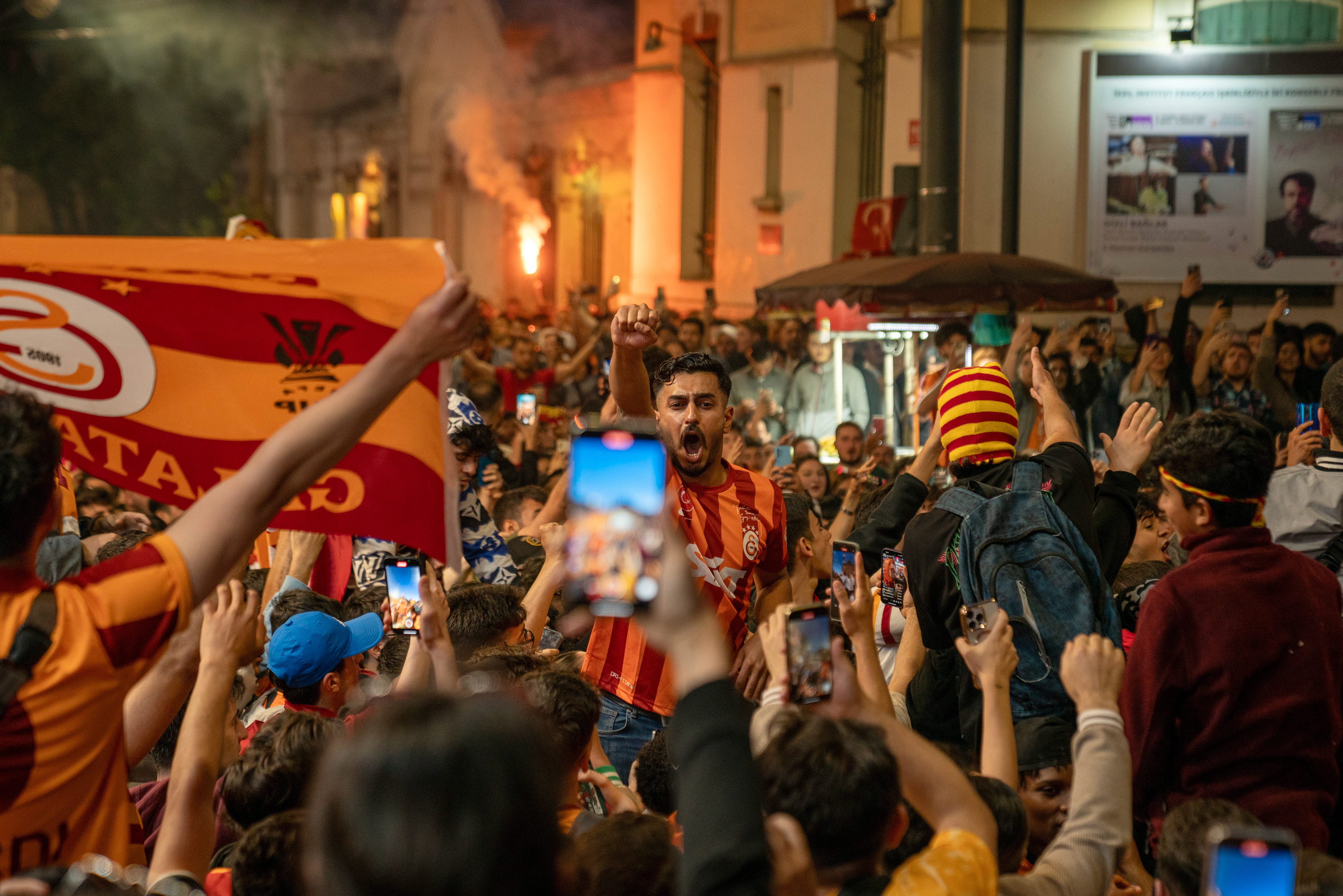 Fans of Galatasaray celebrate after their club won the 24th Turkish league title on May 26, 2024 with a victory against Konya in their last match of the season.