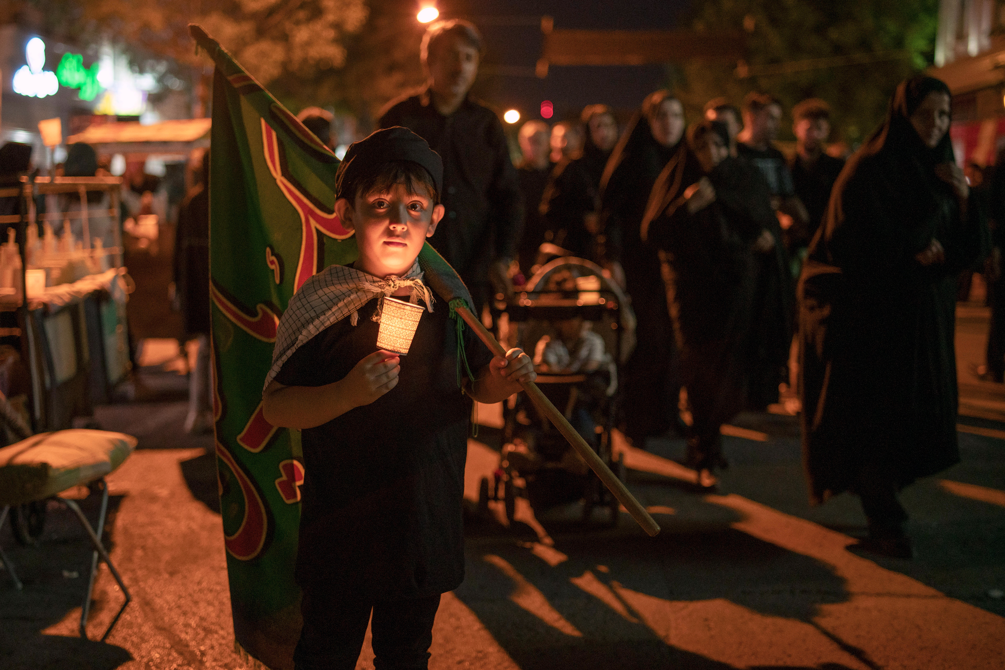 A child in Ardabil, Iran on July 28, 2023, lights a candle to bring 'a light for Imam Hussein' on Ashura Day the 1384th anniversary of Imam Hussein's martyrdom. Shiite Muslims light candles bringing 'a light for Imam Hussein' on the Day of Ashura, unique to the city of Ardabil.