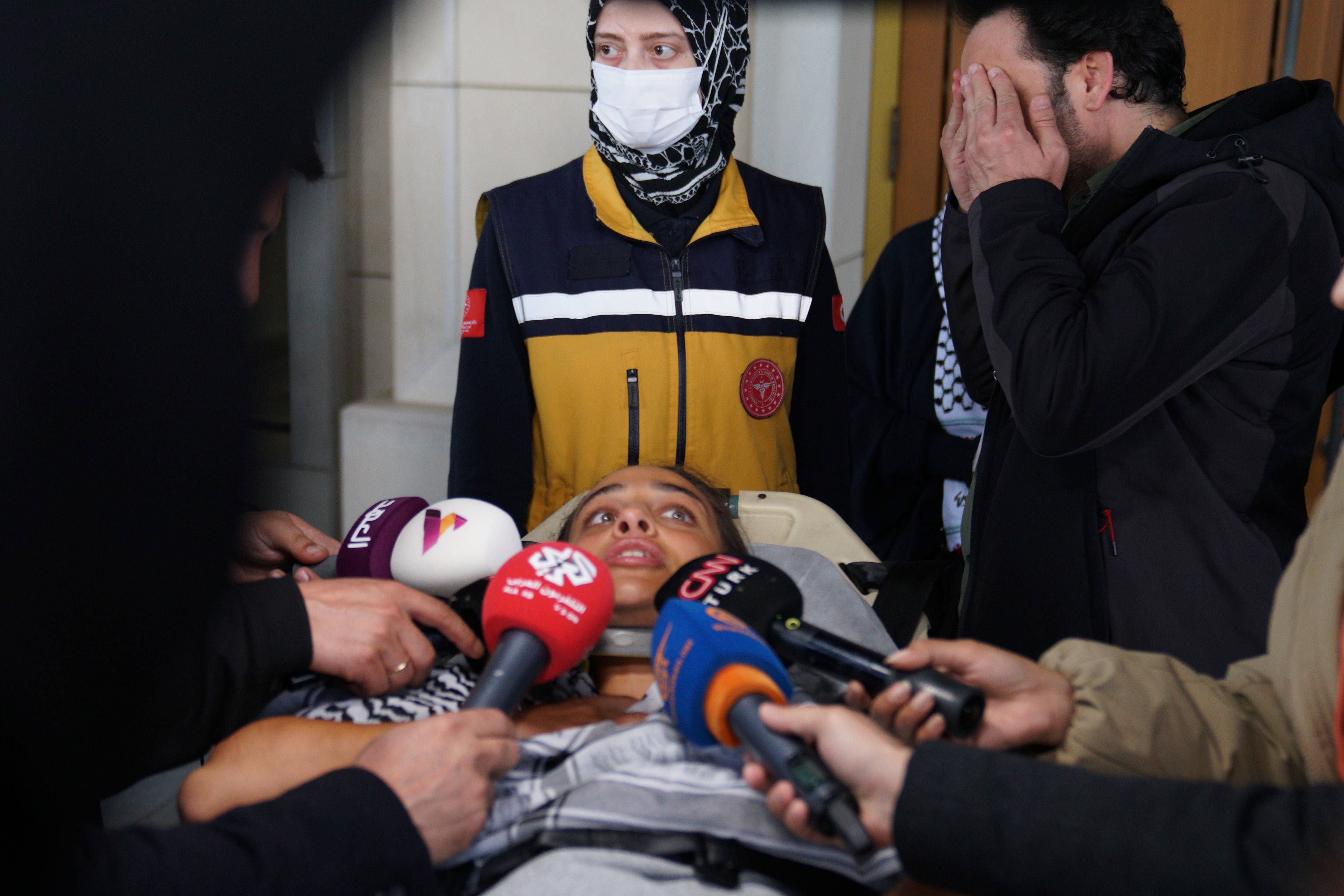 An activist, who was detained aboard the Gaza-bound Global Sumud Flotilla, which was intercepted by Israeli forces, is surrounded by media as she is carried out of the terminal on a stretcher at Istanbul International Airport after being deported, in Istanbul, Turkey, May 21, 2026.
