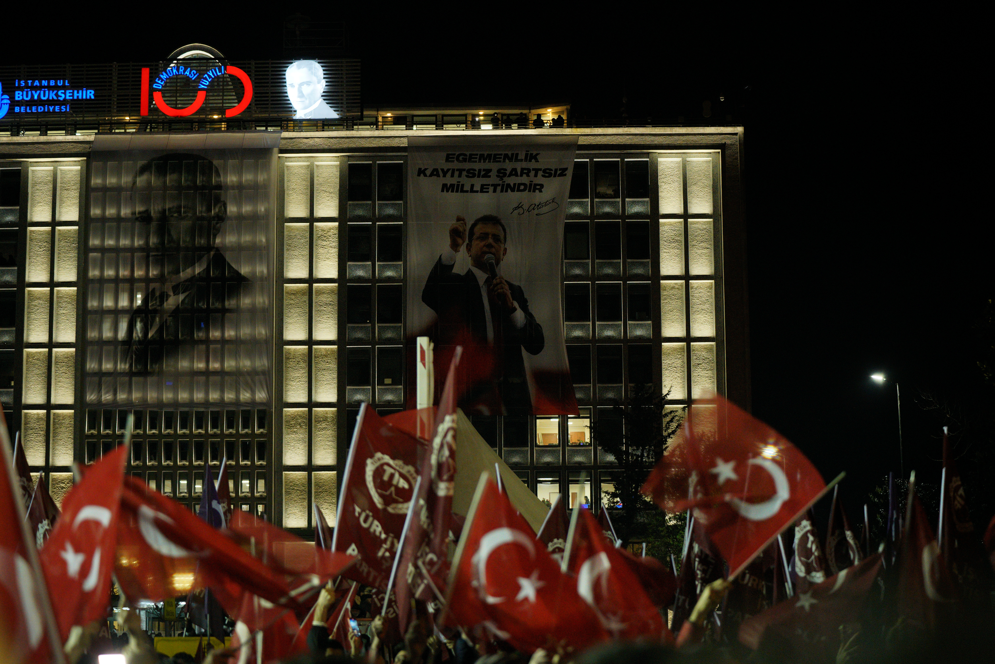 Supporters of Istanbul Mayor Ekrem Imamoglu gather outside the Istanbul Metropolitan Municipality building to protest the detention of Imamoglu, in Istanbul, Turkey, March 19, 2025. 