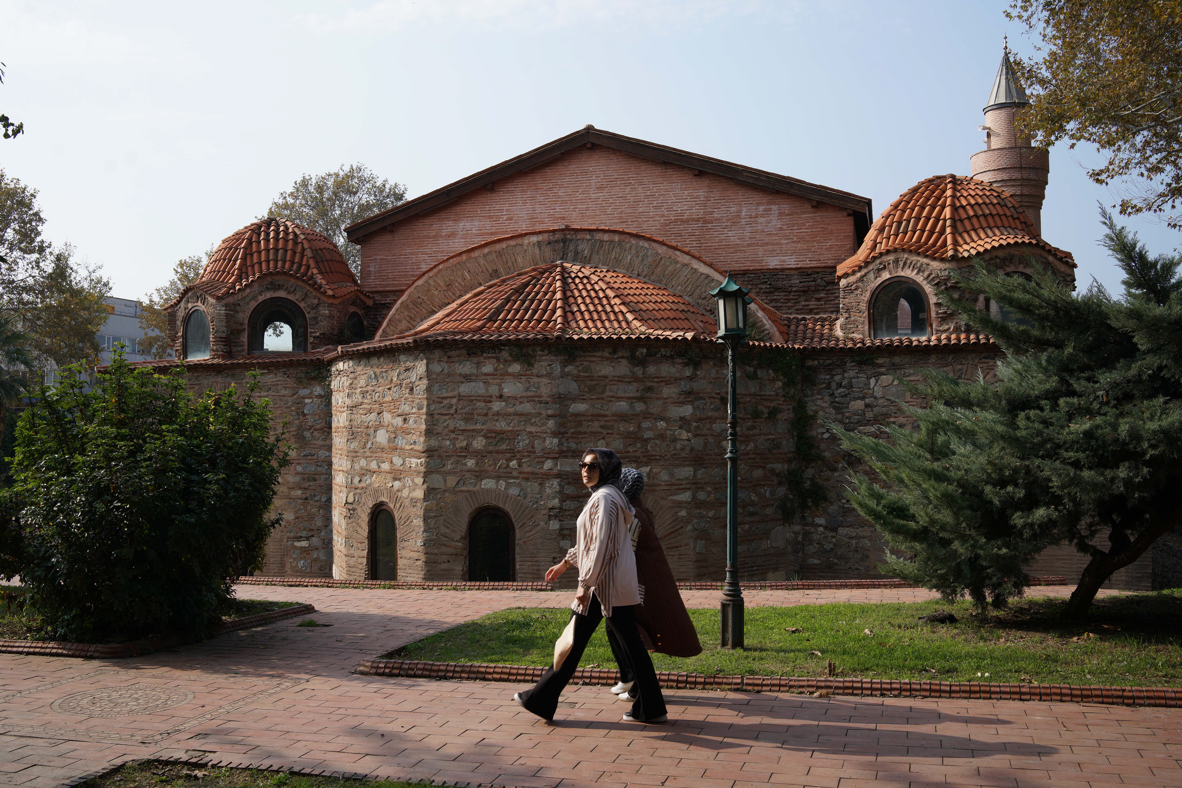 A woman walks past the Hagia Sophia, which was built by Romans as a place of worship, then converted to a church and later into a mosque by the Ottomans, in Iznik, Turkey, where Pope Leo is expected to visit for the 1,700th anniversary of the First Nicaea Council, during his trip to Turkey in November as part of his first trip outside Italy, November 7, 2025.