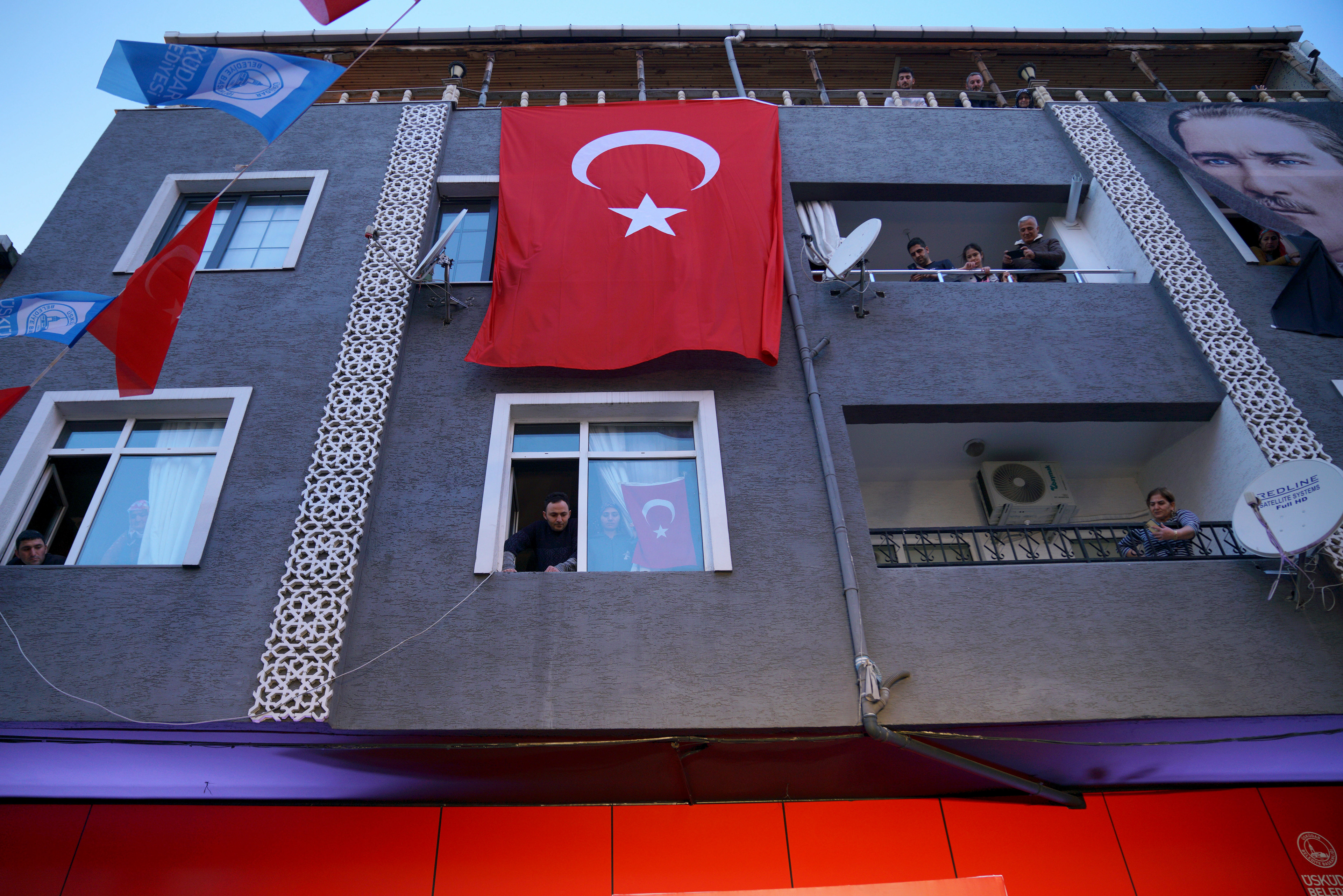 People watch Ekrem Imamoglu (not pictured) from their homes as Istanbul Mayor Ekrem Imamoglu meets with the public ahead of the opening of City Restaurant in Istanbul on March 6, 2025.