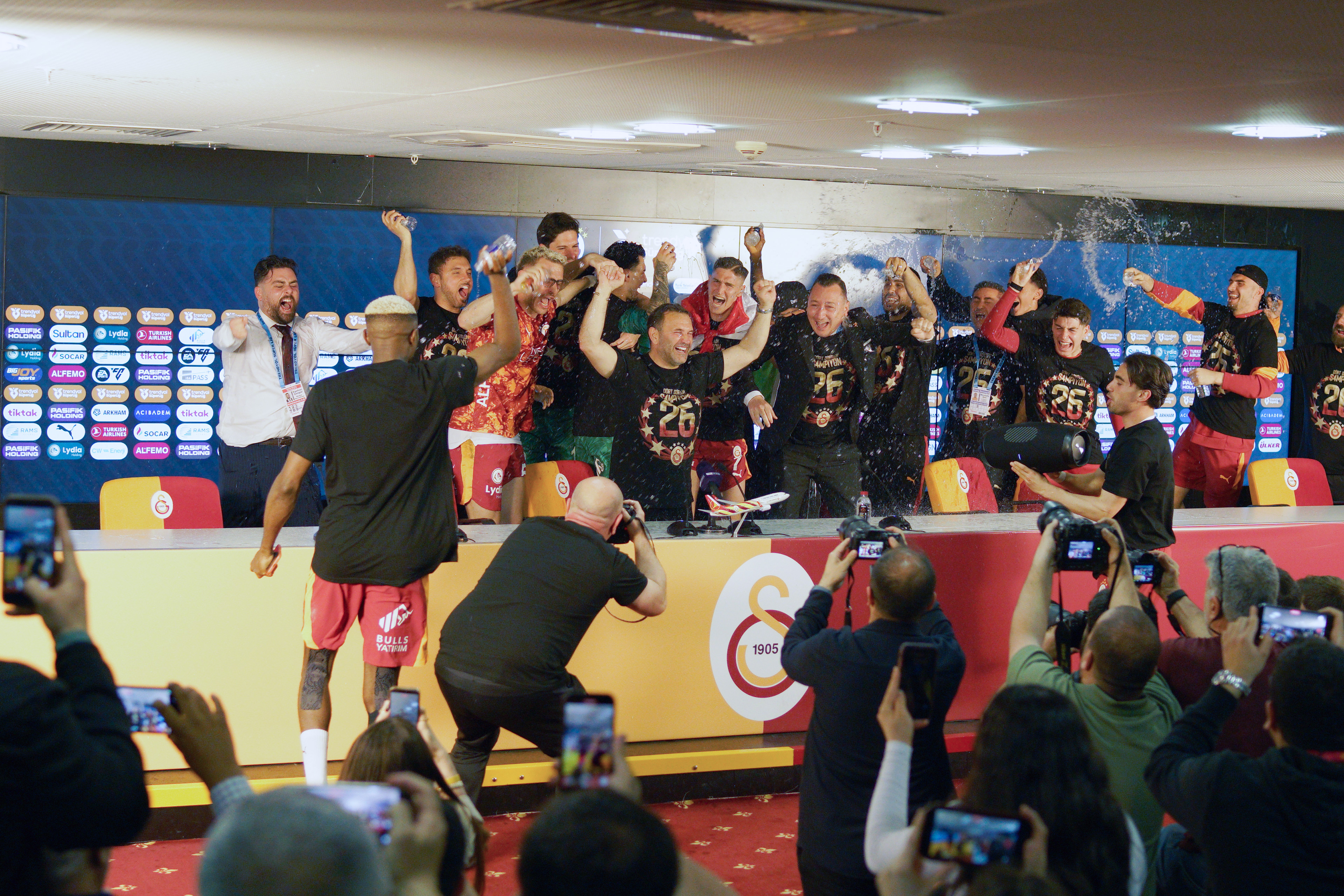 Galatasaray players and coach Okan Buruk celebrating their 2025-2026 Turkish Super League championship in the press room during a match played in Istanbul on May 9, 2026.