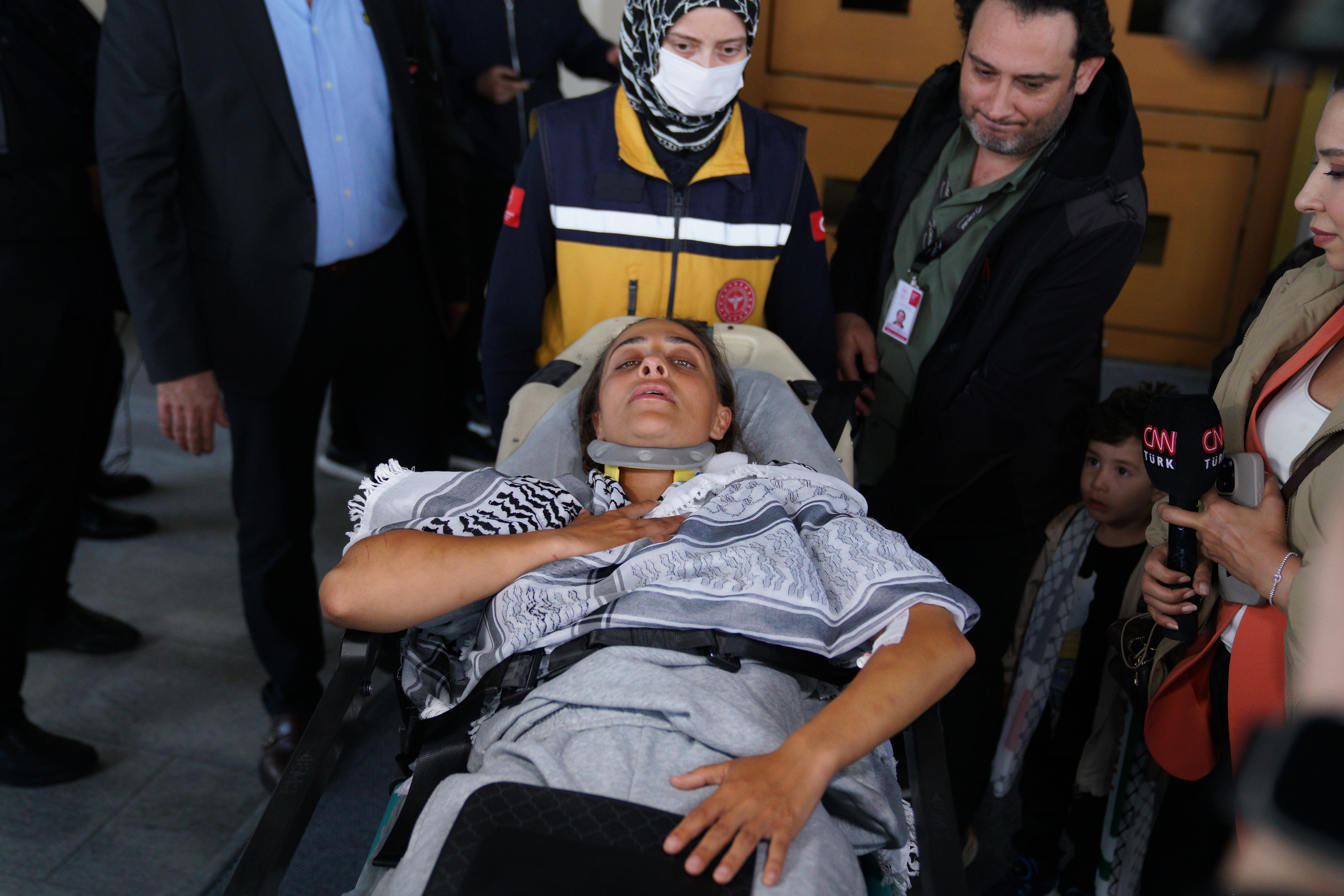 An activist, who was detained aboard the Gaza-bound Global Sumud Flotilla, which was intercepted by Israeli forces, is surrounded by media as she is carried out of the terminal on a stretcher at Istanbul International Airport after being deported, in Istanbul, Turkey, May 21, 2026.