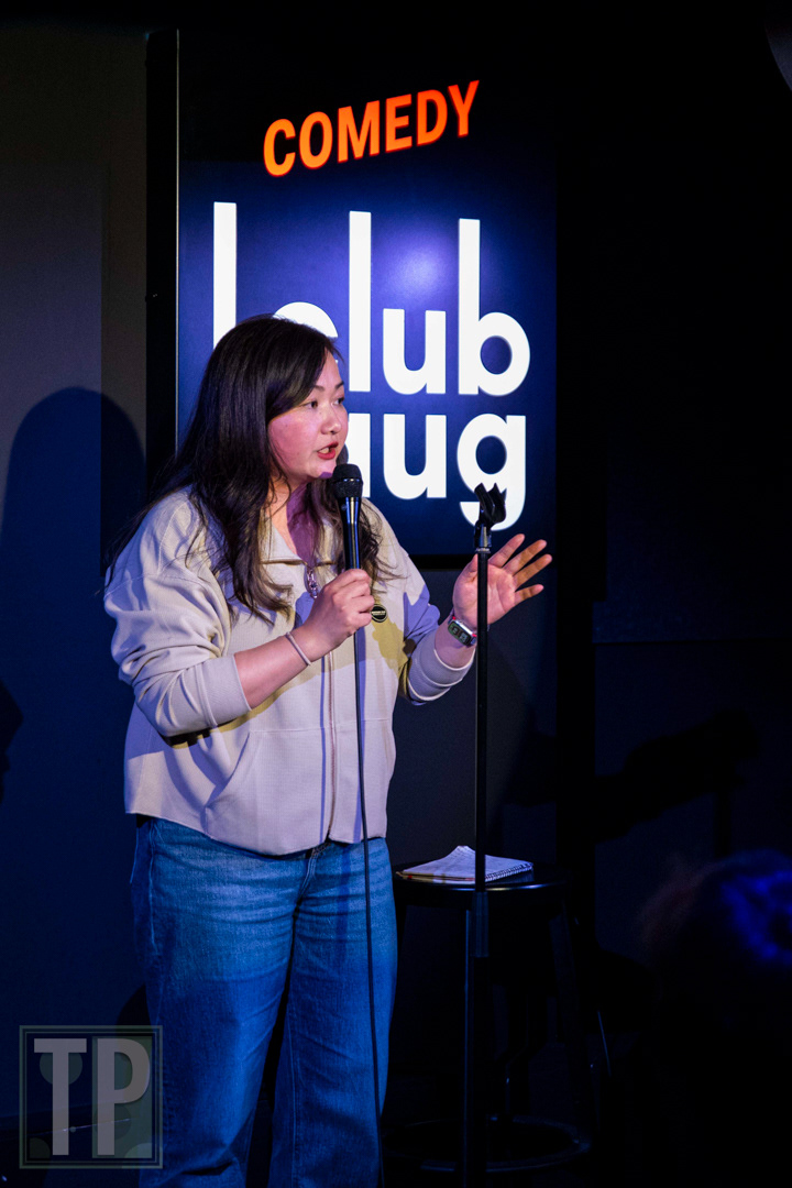 Giselle Wang working the audience on stage during an English open-mic set at Comedy Club Haug in Rotterdam, the Netherlands.