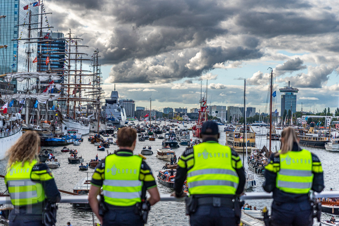 Dutch police officers observe ships entering and leaving Amsterdam’s harbours during SAIL 2025.