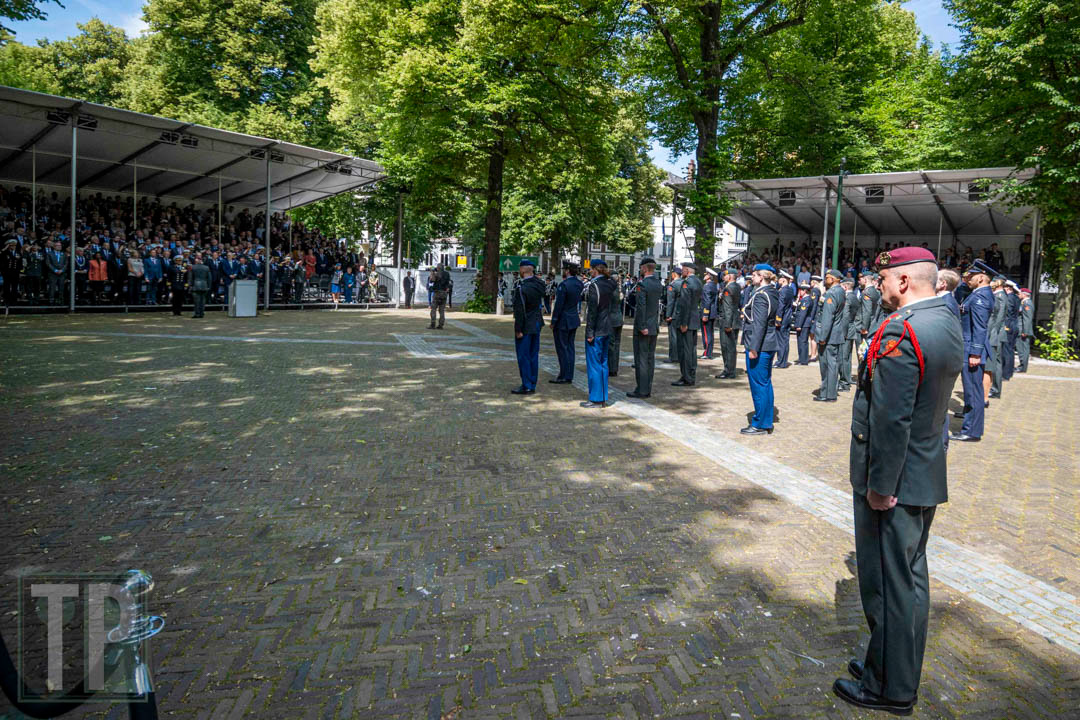 Civilians and soldiers stand at attention during a ceremony to receive the Dutch Peace Operations Medal.