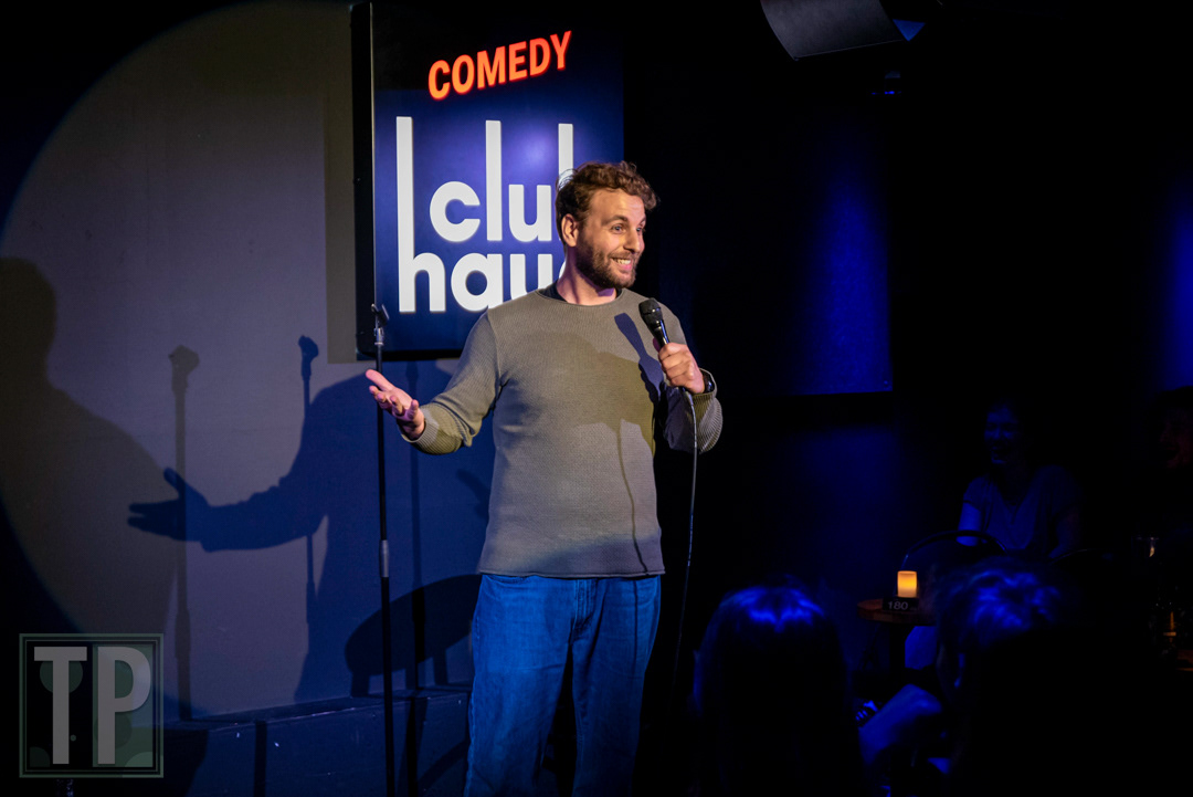 Comedian Semir Dahha stoking the audience on stage during an English open-mic set at Comedy Club Haug in Rotterdam, the Netherlands.