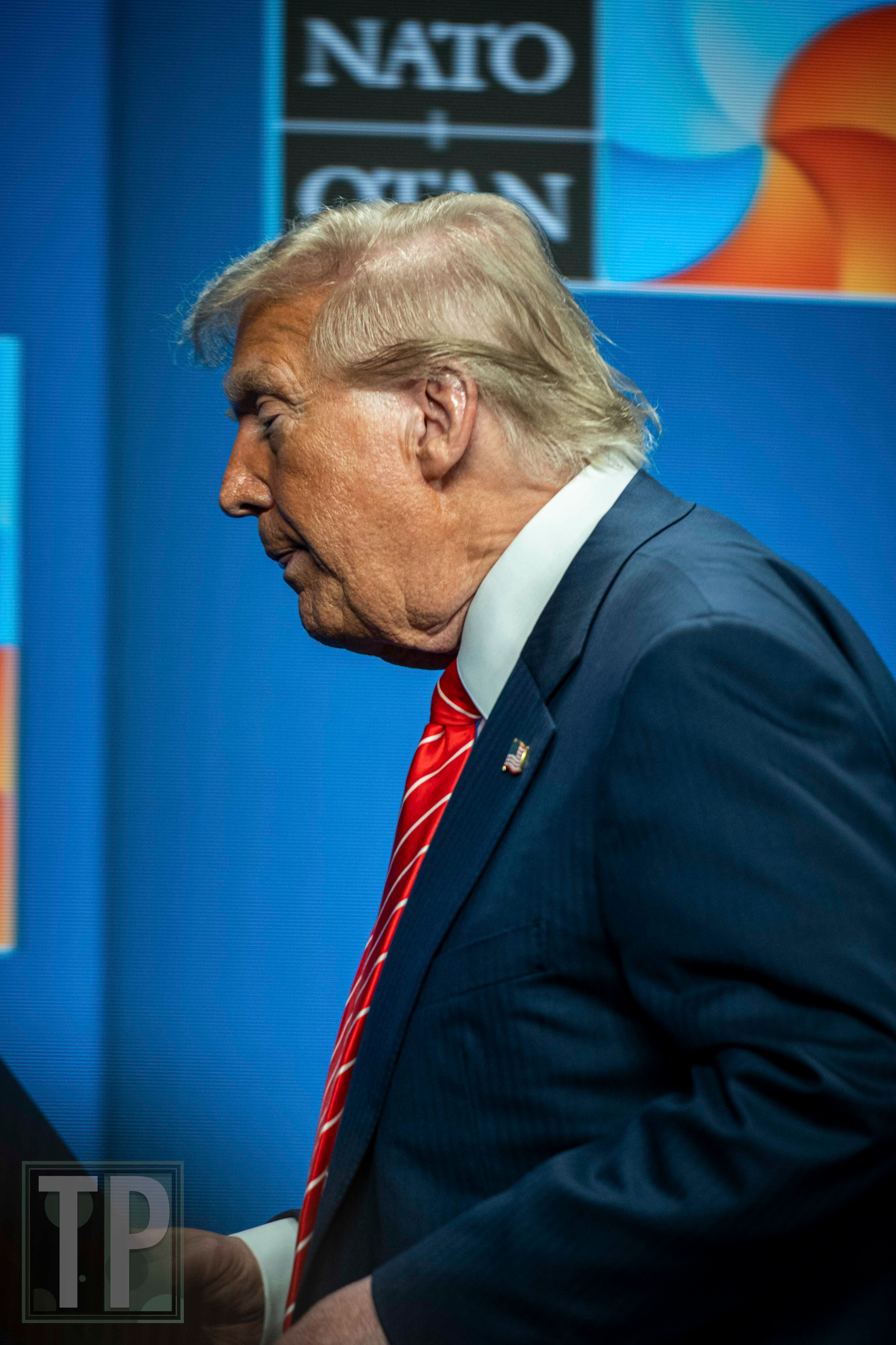 Following a contentious press conference that addressed the resolution of the 2025 NATO Summit, US President Donald Trump departs the stage.