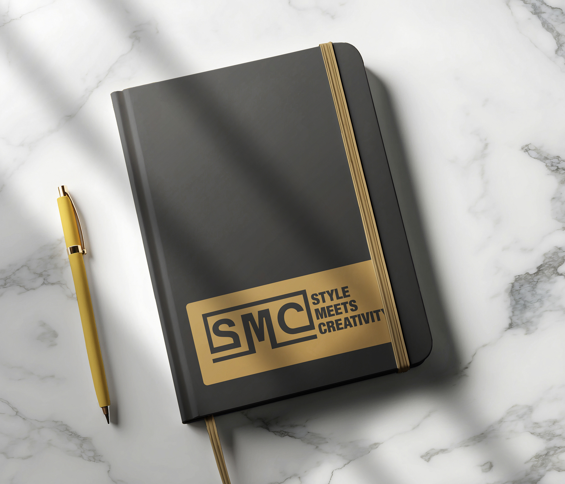 A promotional notebook and pen set designed in harmony with the SMC brand identity.