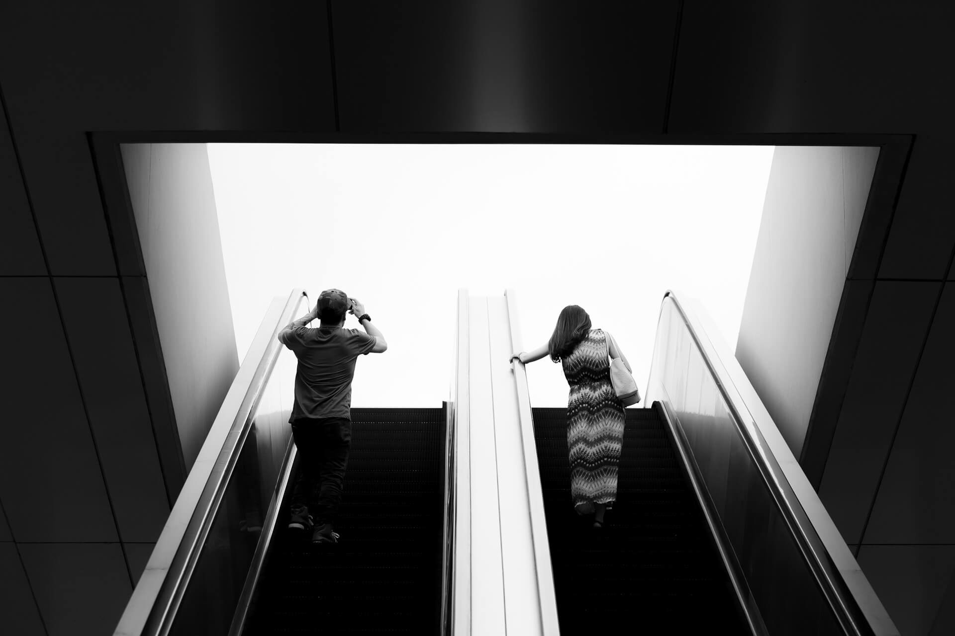 Two people on an escalator going up, Singapore