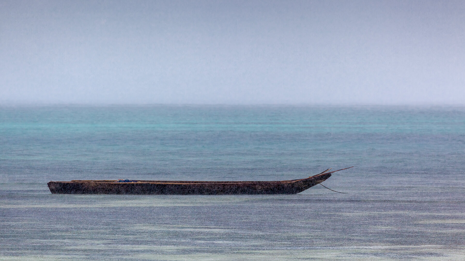 Fishing boat in the rain at the shore of Zanzibar
