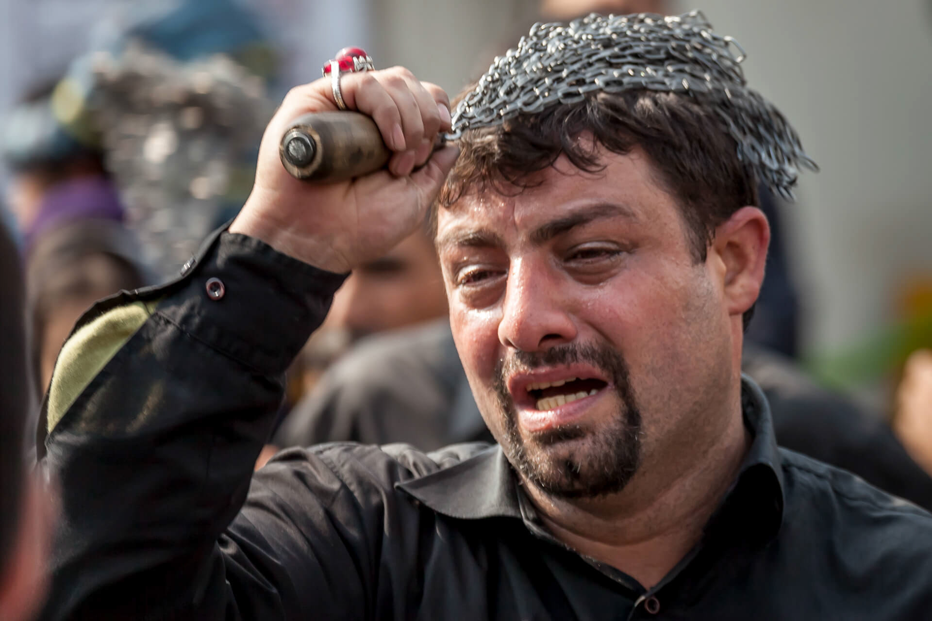 A man strikes his head with a chain whipduring the Remembrance of Muharram in Tehran, Iran