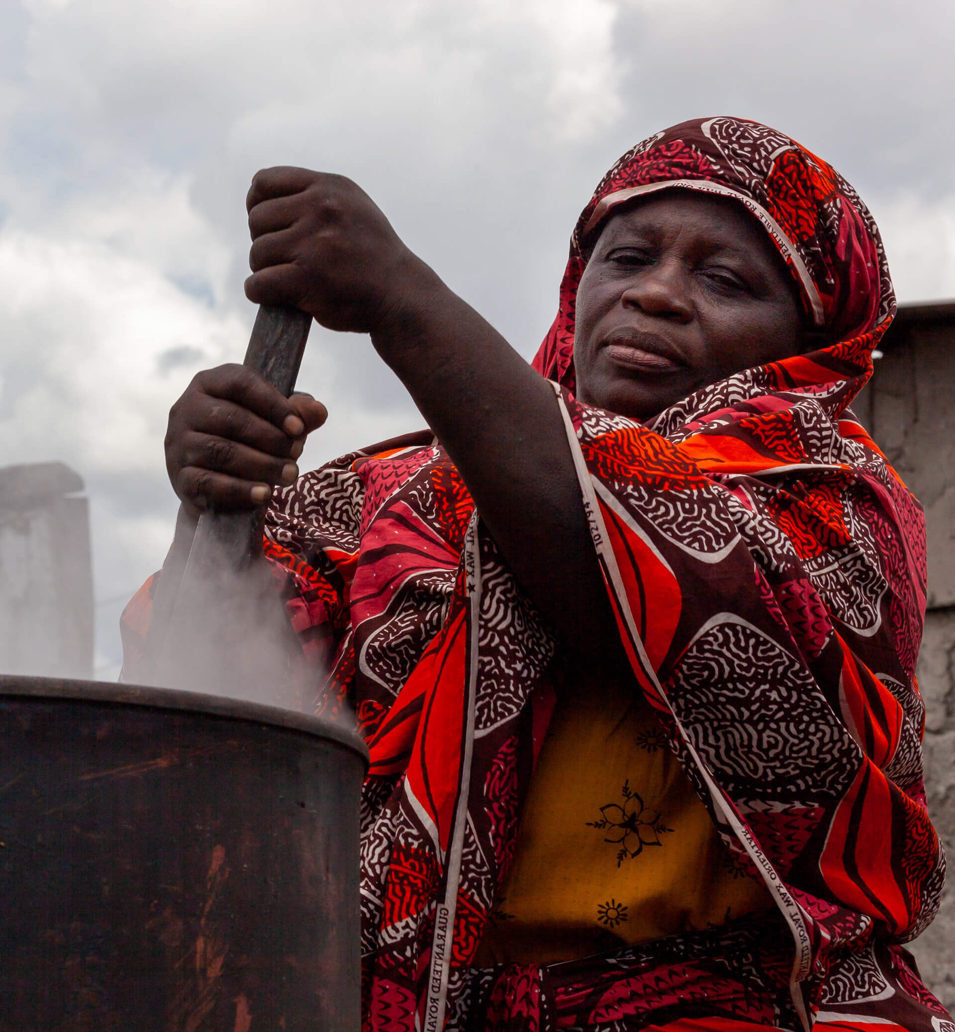 Elderly woman working in an township brewery in Makumbusho, Dar es Salaam, Tanzania