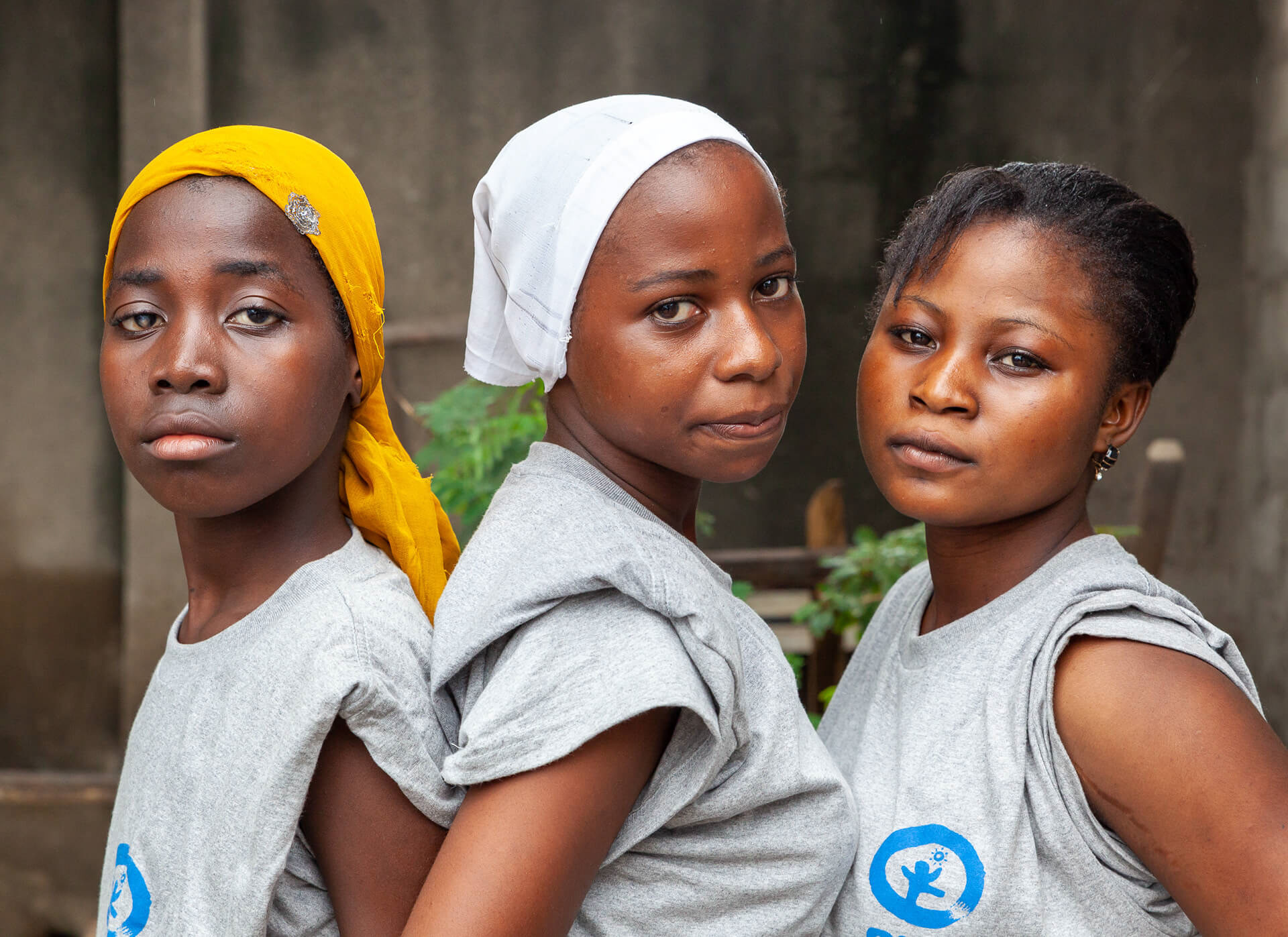 Three young women, volunteers at a HIV/AIDS prevention event in Vingunguti, Dar es Salaam, Tanzania