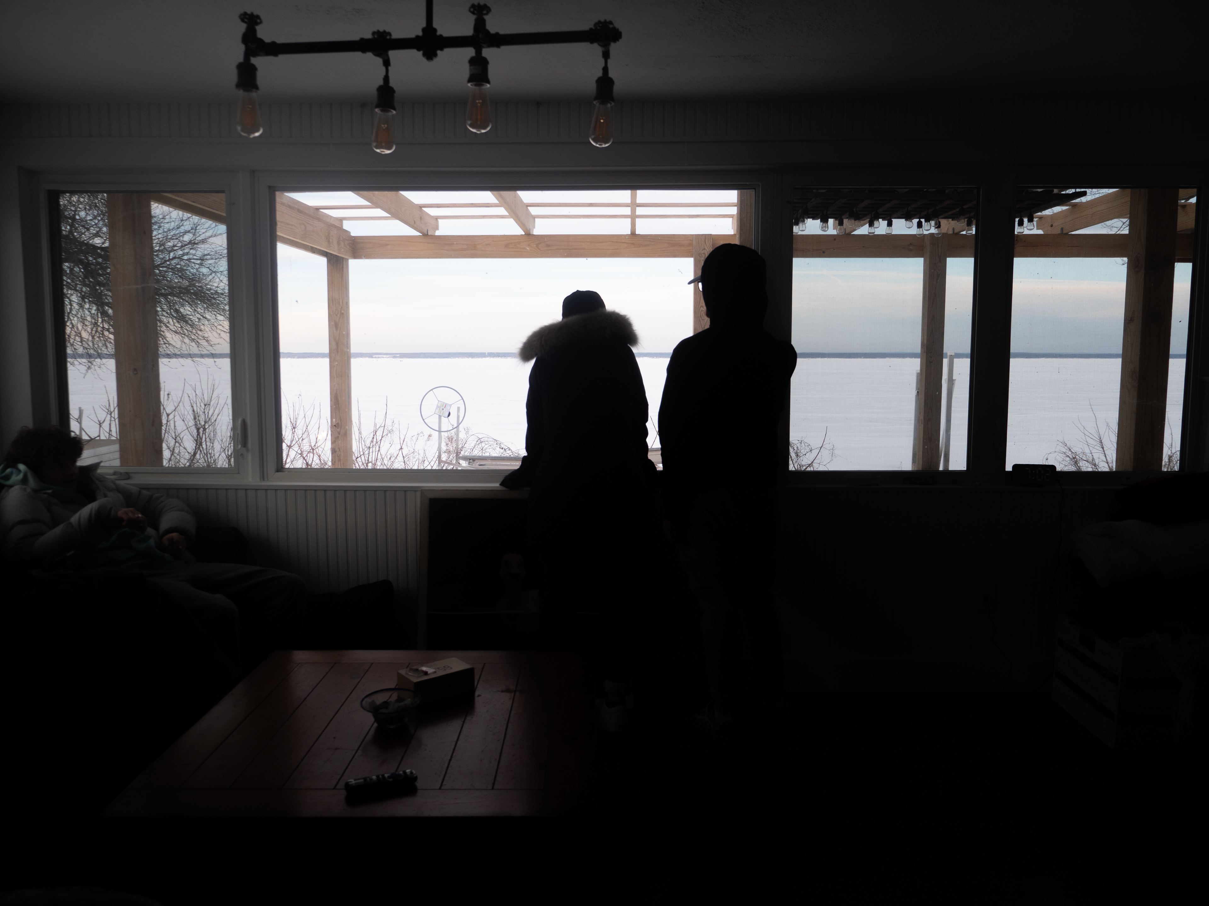 Jenna Bondy and Ryan Blowers peering outside the window. 