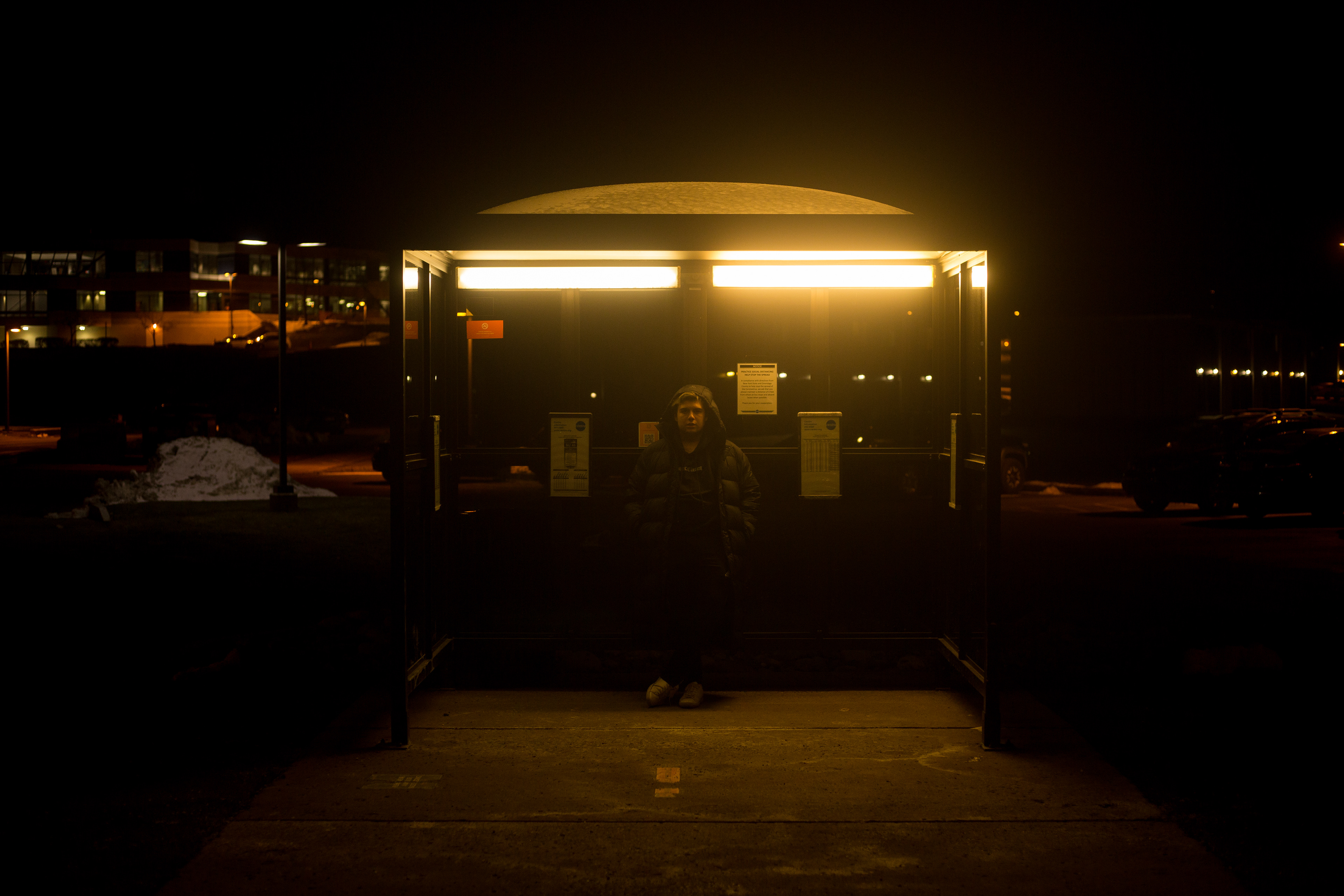 Mariano Gama waiting at the bus stop.