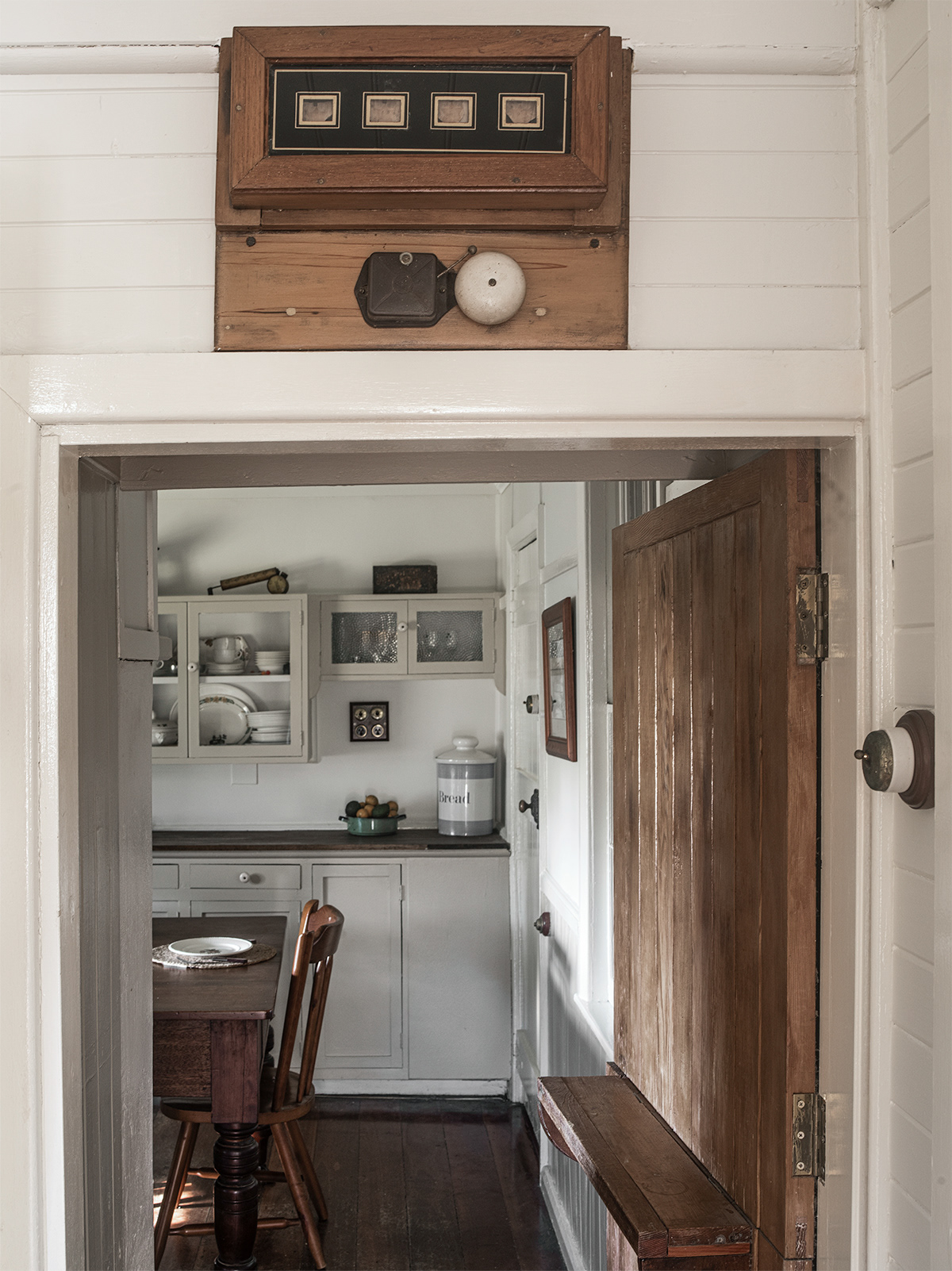 Servants bell indicator sits above the doorway between the dining room and kitchen.