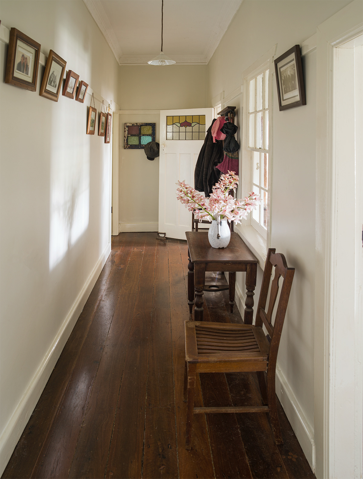 This is an image of renovated hallway number 1. Freshly painted trims and walls (Dulux China Plate). Orchids courtesy of our garden