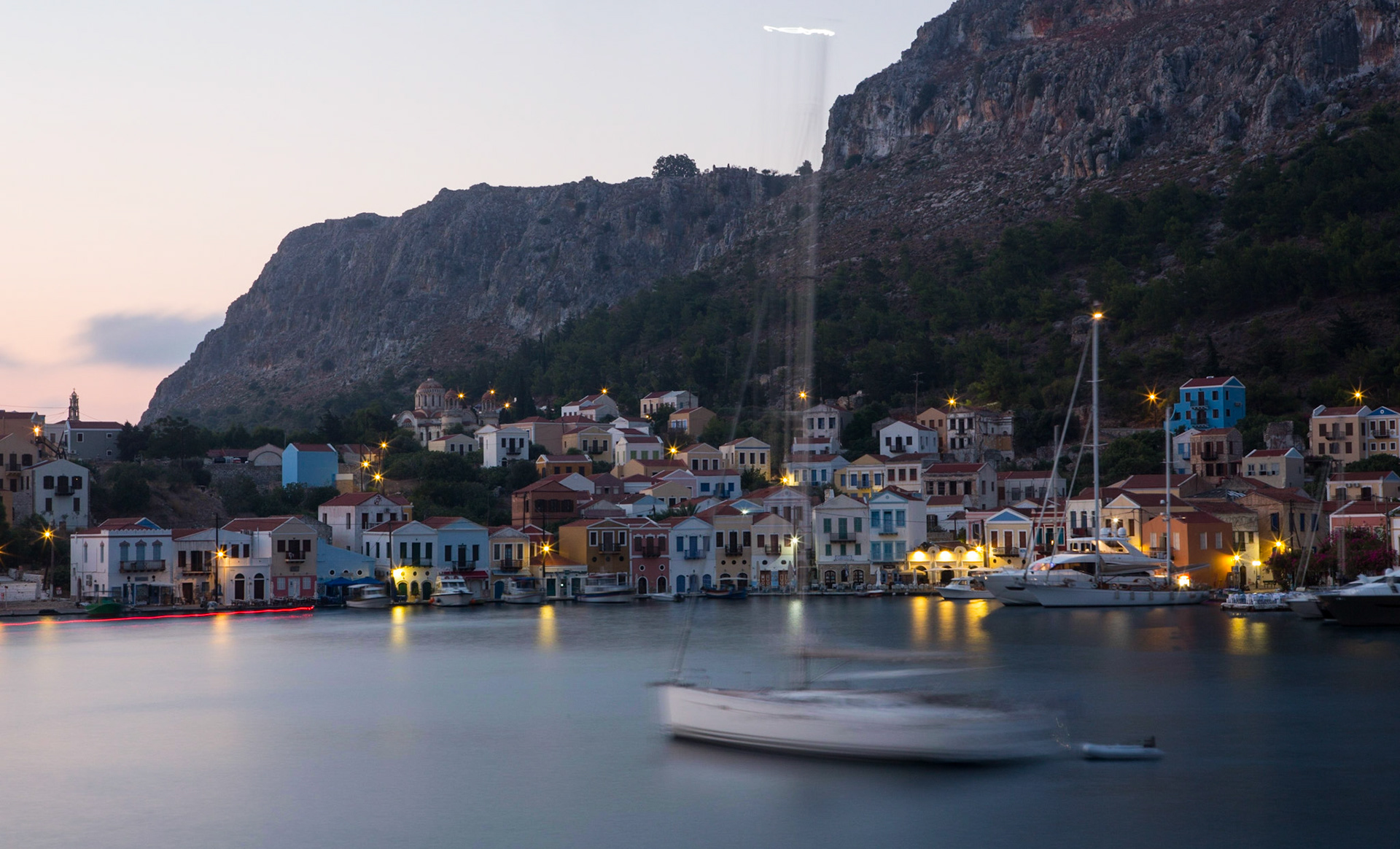 Kastellorizo (Greek: Καστελλόριζο) is a Greek island located roughly 2 kilometres off the south coast of Turkey. The island's official name, Megisti (Μεγίστη) means "biggest", as it is the largest of the small archipelago, while in fact it is the smallest of the Dodecanese. It is such a precious moment to watch the fading light over the colorful houses at sunset.