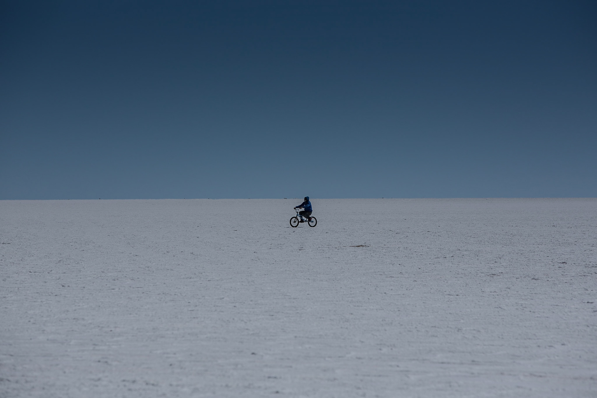 Salar de Uyuni is the world's largest salt flat at 10,582 square kilometers. It is located in Potosí in southwest Bolivia, near the crest of the Andes and is at an altitude of 3,656 meters above sea level.The Salar was formed as a result of transformations between several prehistoric lakes. It is covered by a few meters of salt crust, which has an extraordinary flatness. The crust serves as a source of salt and covers a pool of brine, which is exceptionally rich in lithium. The place has an end-of-the-world feel to it and invites to explore using any means of transportation.