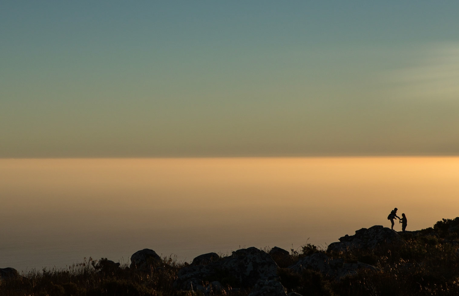 Table Mountain is a flat-topped mountain forming a prominent landmark overlooking the city of Cape Town in South Africa. It is a significant tourist attraction, with many visitors using the cableway or hiking to the top. The best moment to go is in the afternoon, with fewer tourists and an incredibly beautiful light