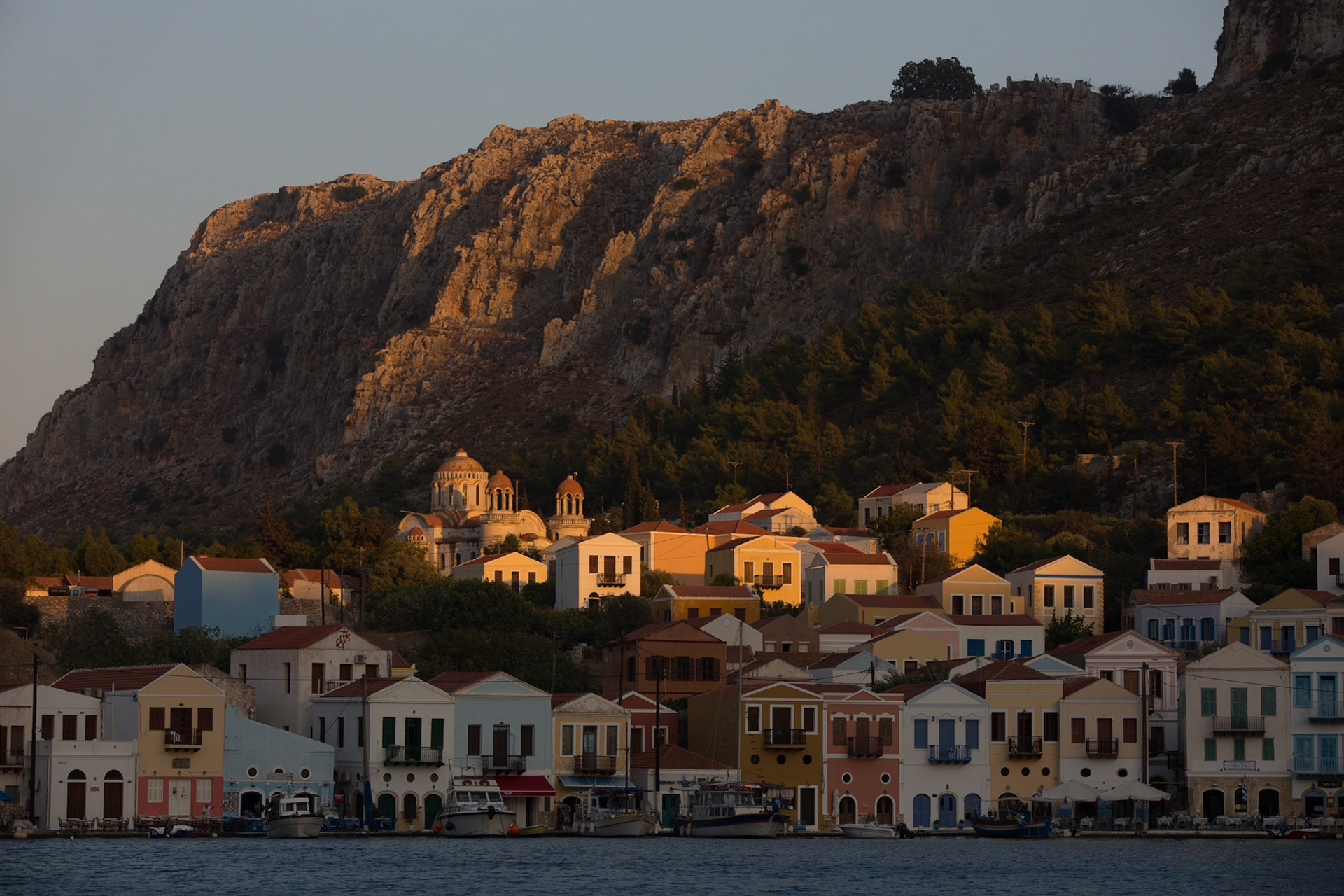 Kastellorizo (Greek: Καστελλόριζο) is a Greek island located roughly 2 kilometres off the south coast of Turkey. The island's official name, Megisti (Μεγίστη) means "biggest", as it is the largest of the small archipelago, while in fact it is the smallest of the Dodecanese. It is such a precious moment to watch the fading light over the colorful houses at sunset.