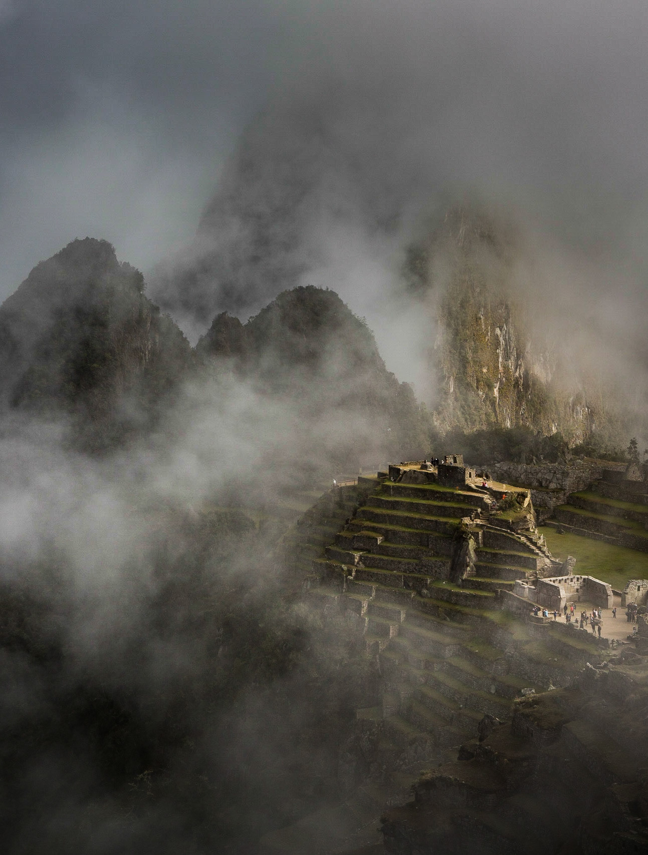 Machu Picchu, Peru, stands 2,430 m above sea-level, in the middle of a tropical mountain forest, in an extraordinarily beautiful setting. The site opens at 06:00 a.m. just before the sunrise. Very often, the morning fog prevents the visitors from seeing the first light but, after a while, a magical and mysterious atmosphere is revealed and the light starts playing with the fog... I had a luminous experience while meditating there years ago and decided to come back alone with my camera.