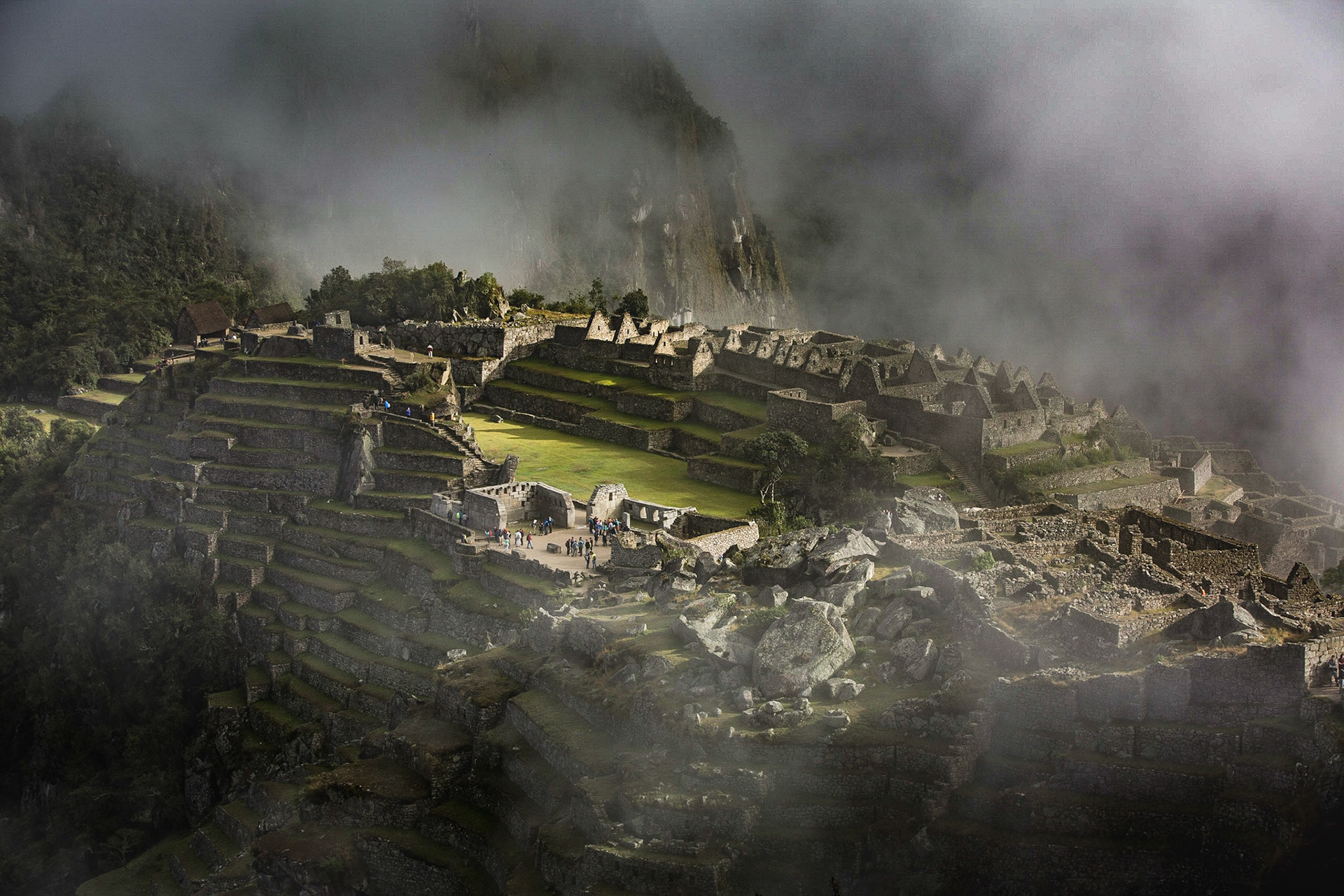 Machu Picchu, Peru, stands 2,430 m above sea-level, in the middle of a tropical mountain forest, in an extraordinarily beautiful setting. The site opens at 06:00 a.m. just before the sunrise. In many cases, the morning fog prevents the visitors from seeing the first light. However, after a while, a magical and mysterious atmosphere is revealed and the light starts playing with the fog...