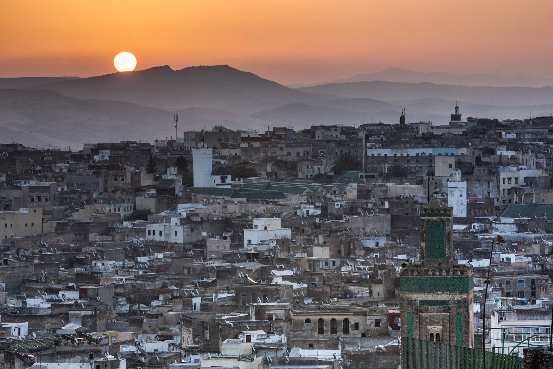 Fez is the third largest city of Morocco, after Casablanca and Rabat.Fez was the capital city of modern Morocco until 1925. It is listed as a World Heritage Site and is believed to be one of the world's largest urban pedestrian zones (car-free areas) with more than 8,000 small streets in the medina) old town). This shot was taken at sunrise from the rooftop of a Riad located at the heart of the medina.