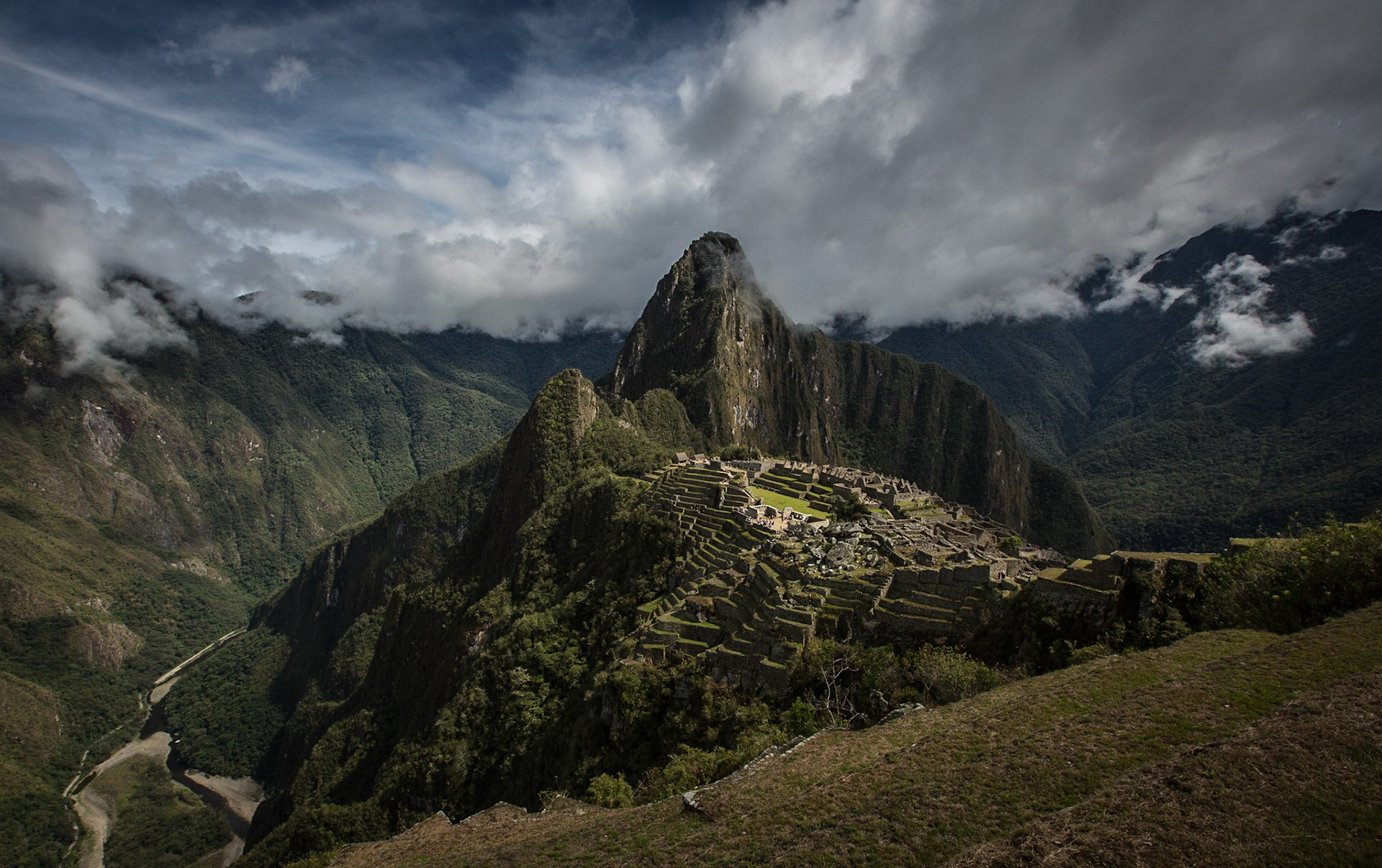 Machu Picchu, Peru, stands 2,430 m above sea-level, in the middle of a tropical mountain forest, in an extraordinarily beautiful setting.  I stayed in the site for a full day: from 06:00 (just before sunrise), enjoying and picturing an amazing mixture of light and fog, until 17:00 (closing time) when you almost have the ruins to yourself...