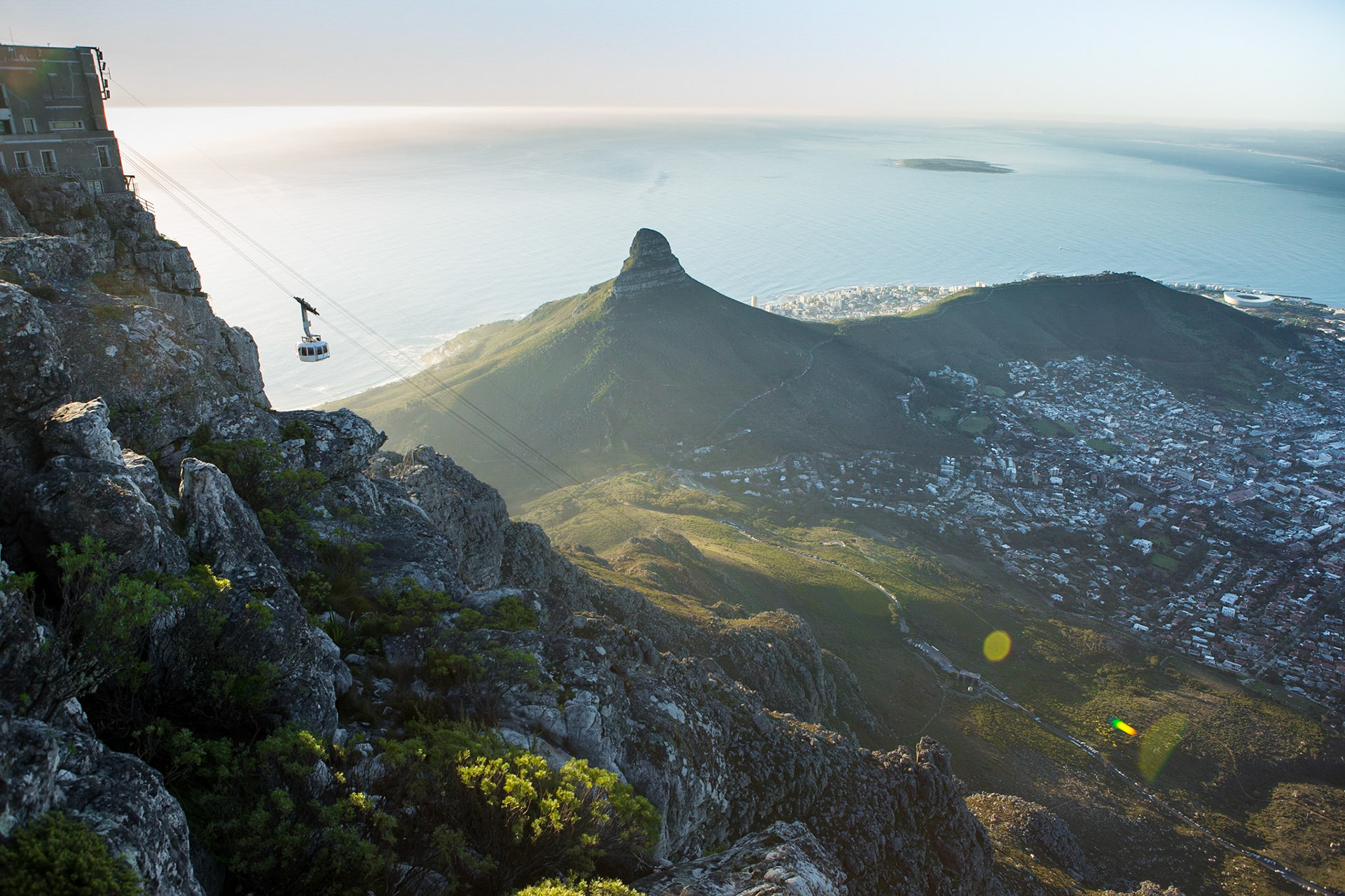 Table Mountain is a flat-topped mountain forming a prominent landmark overlooking the city of Cape Town in South Africa. It is a significant tourist attraction, with many visitors using the cableway or hiking to the top.