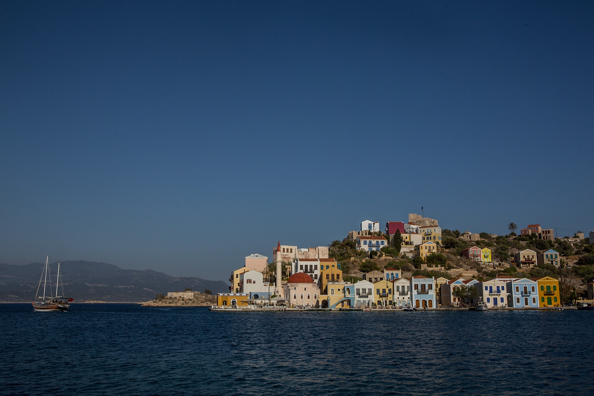 Kastellorizo (Greek: Καστελλόριζο Kastellorizo; officially Μεγίστη Megisti or Meyisti) is a Greek island and municipality located in the southeastern Mediterranean. It lies roughly 2 kilometres off the south coast of Turkey. The island's official name, Megisti (Μεγίστη) means "biggest" or "greatest", but at only 11.98 km2 in area, it is the smallest of the Dodecanese. The name, however, refers to the fact that it is the largest of the small archipelago. This name was used in antiquity, but is now rarely used in Greek.